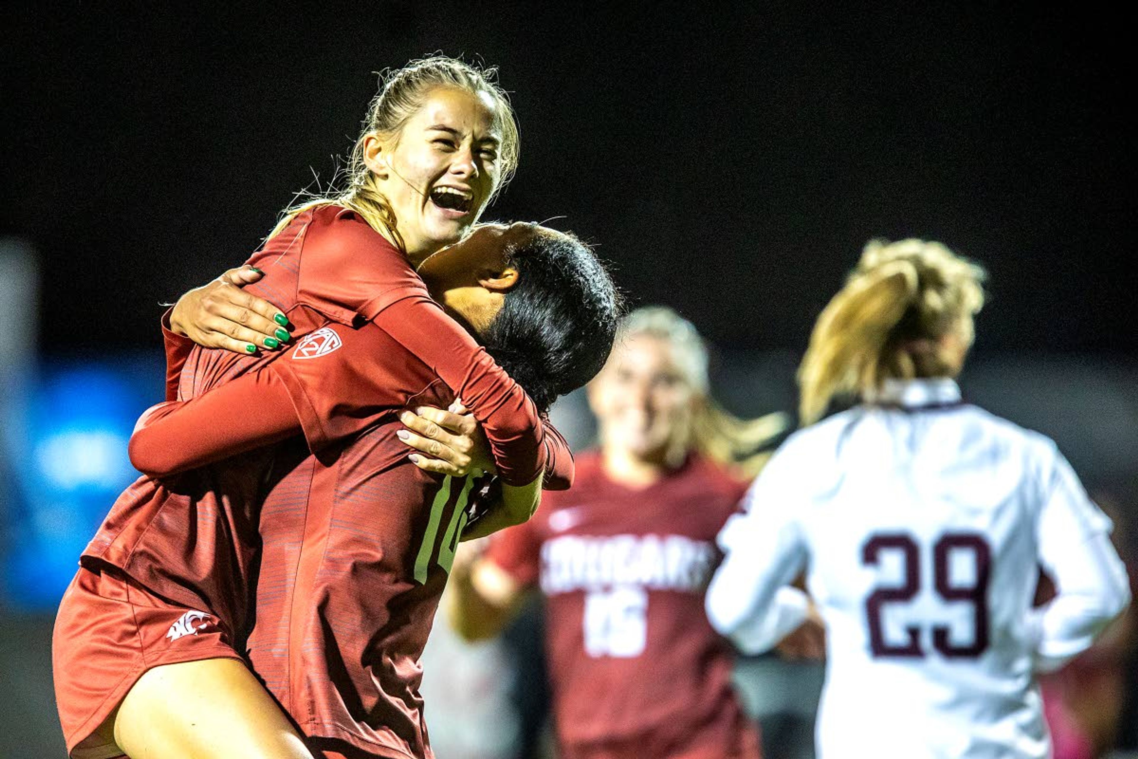 Washington State forward Grayson Lynch is congratulated by teammate Margie Detrizio as they celebrate Lynch’s goal during Saturday’s 3-0 NCAA tournament first-round victory against Montana at Lower Soccer Field.