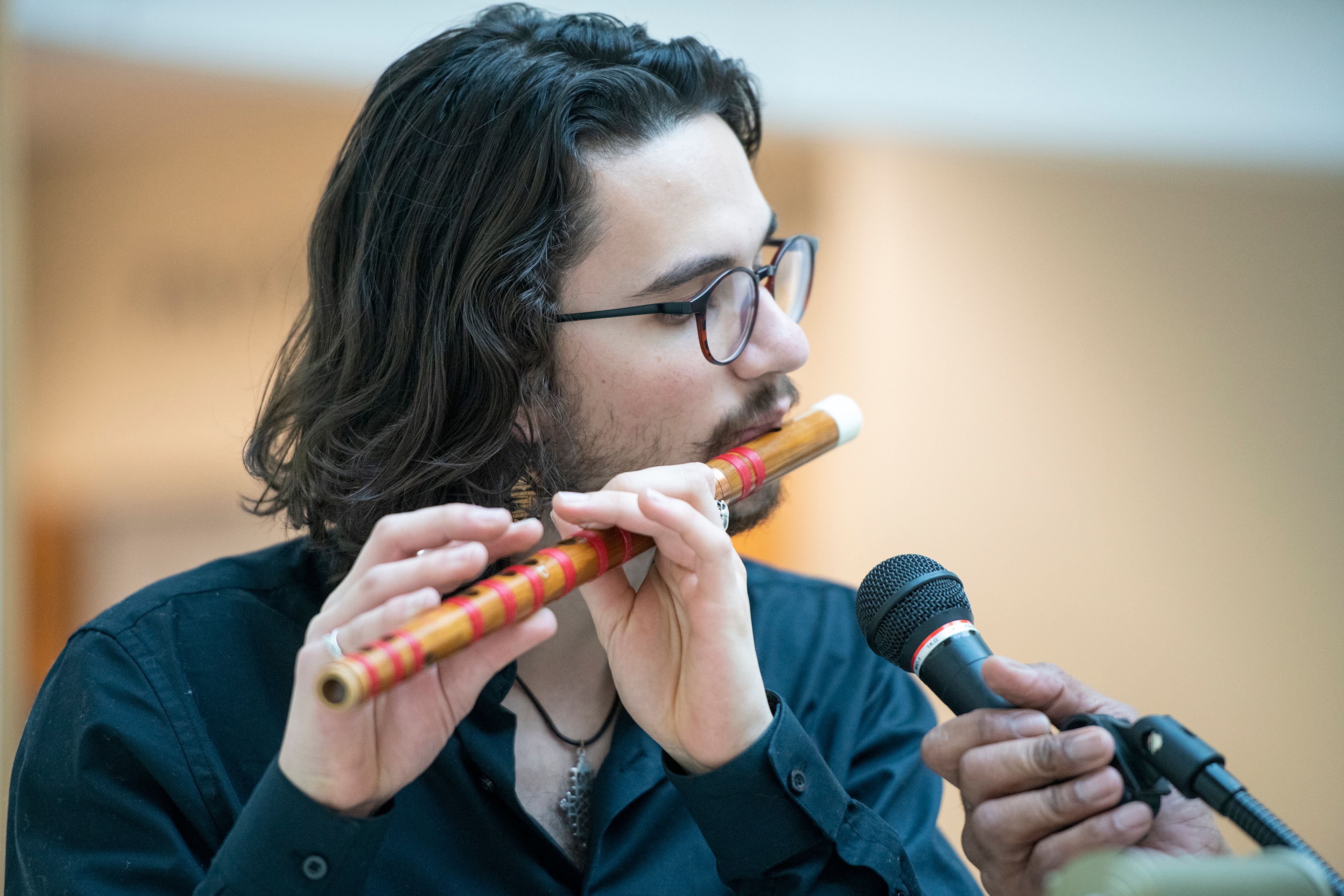 Rogan Tinsley plays the flute in a drum circle Tuesday at Washington State University’s Terrell Library Atrium in Pullman for the National Day of Racial Healing.