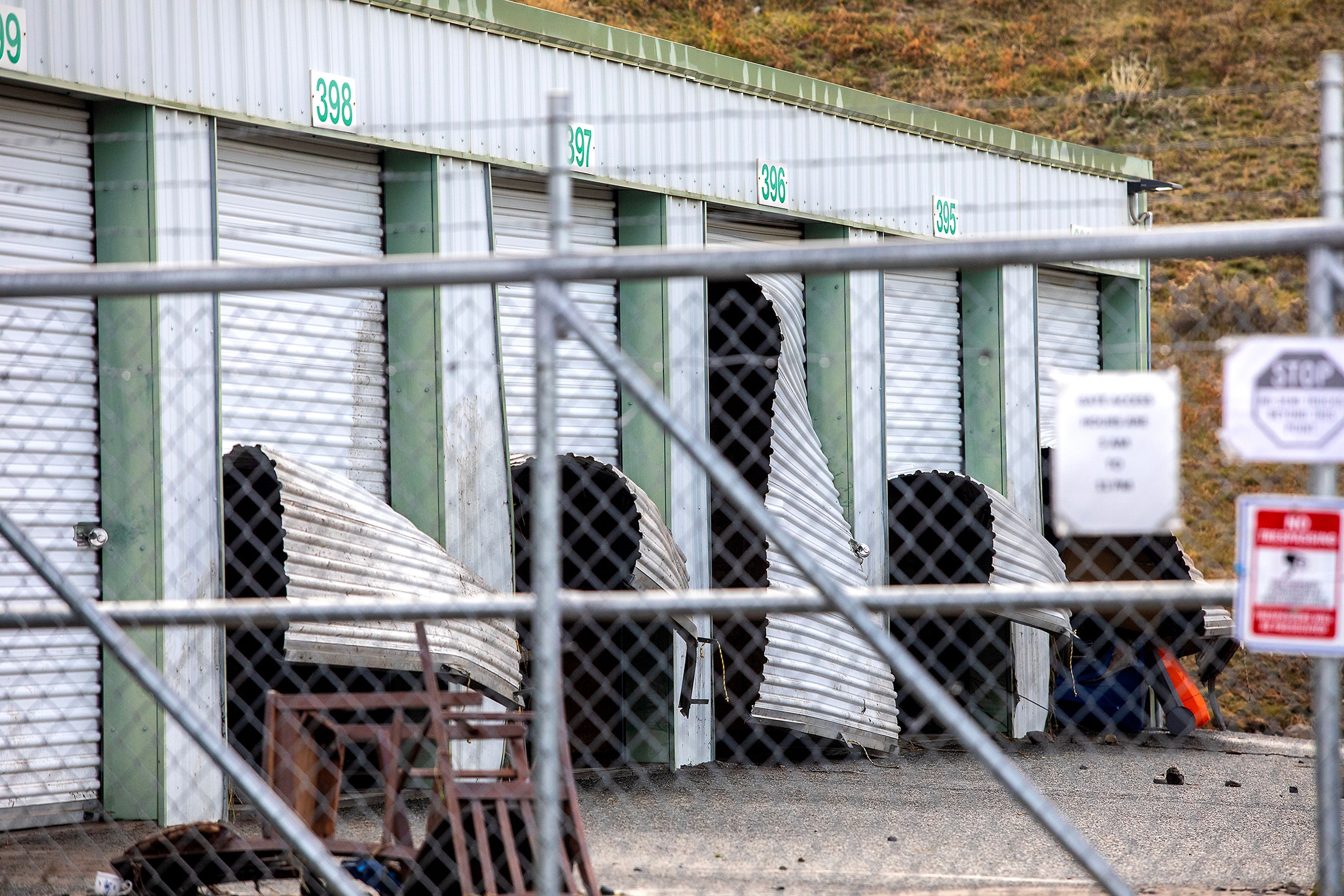 Metal storage unit doors at 16th Avenue Mini Storage are pictured broken upwards after a water reservoir at the corner of 16th Avenue and 29th Street burst in the early hours of Wednesday morning in Lewiston.