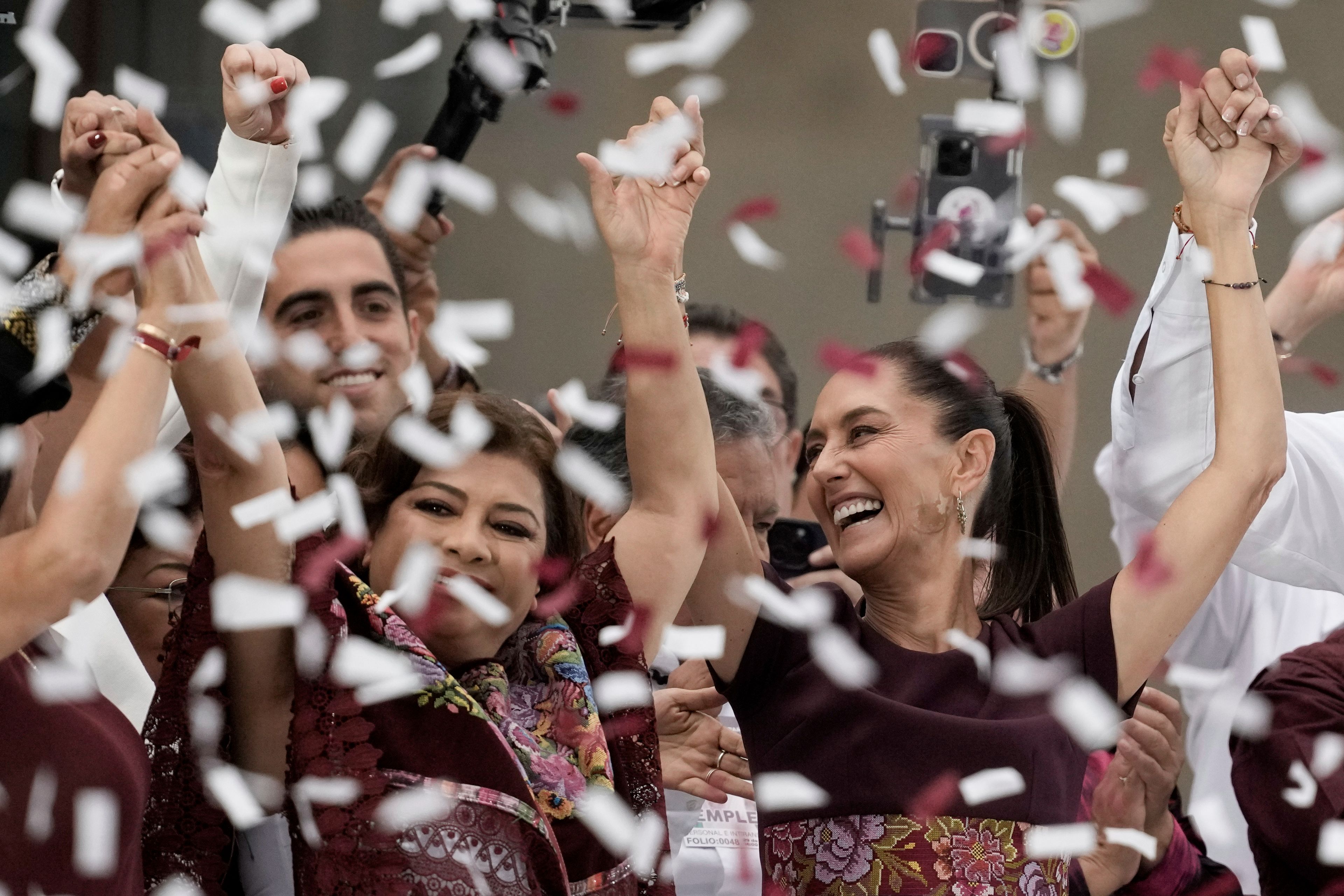 FILE - Confetti showers presidential candidate Claudia Sheinbaum, right, during her closing campaign rally at the Zocalo in Mexico City, May 29, 2024. Sheinbaum, a climate scientist and former Mexico City mayor, will be sworn in as Mexicoâ€™s first woman president on Oct. 1. (AP Photo/Eduardo Verdugo, File)