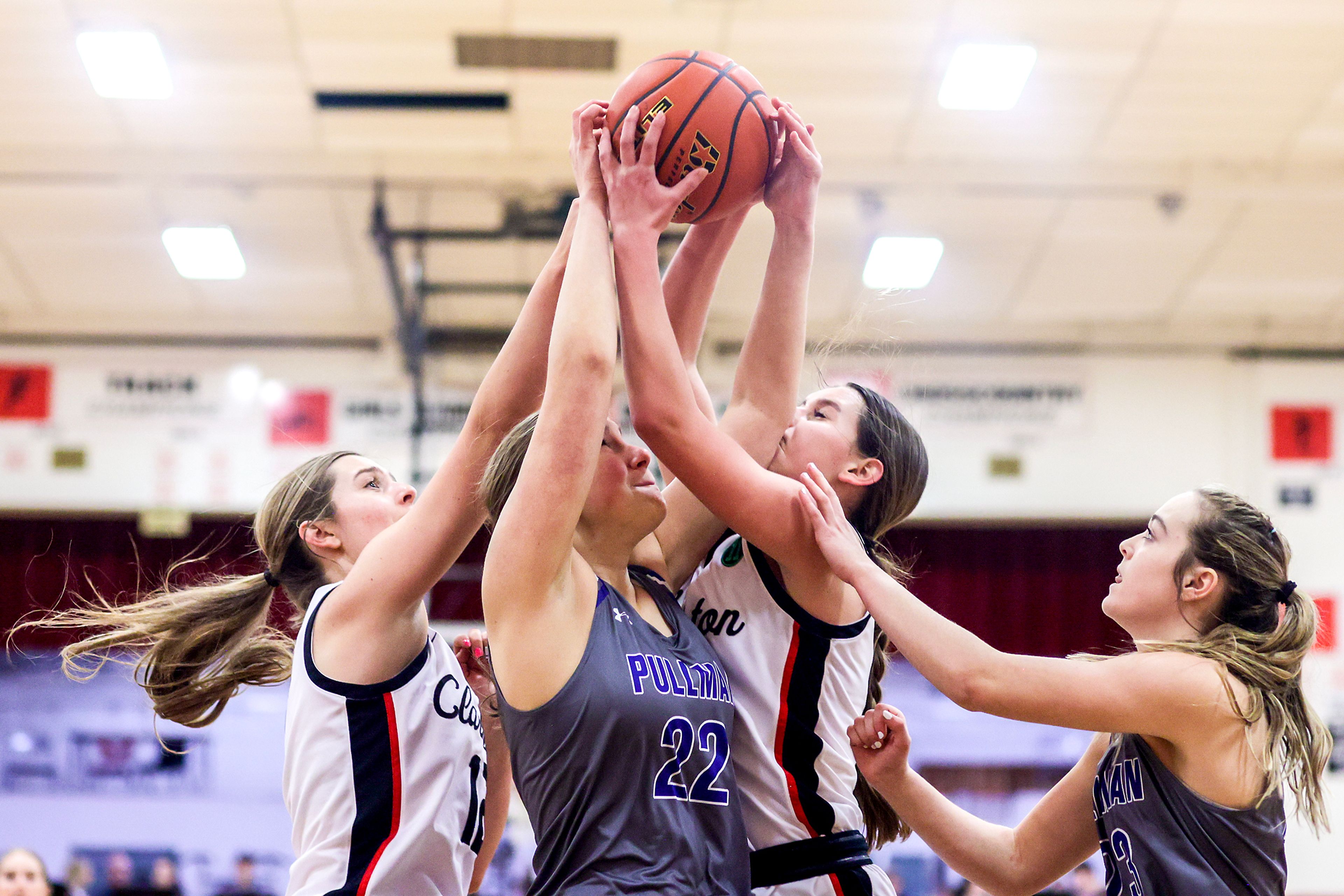 Pullman post Marissa Carper, center, competes with Clarkston wing Ryann Combs, left, and wing Ella Leavitt for a rebound during Tuesday's Class 2A Greater Spokane League girls basketball game.