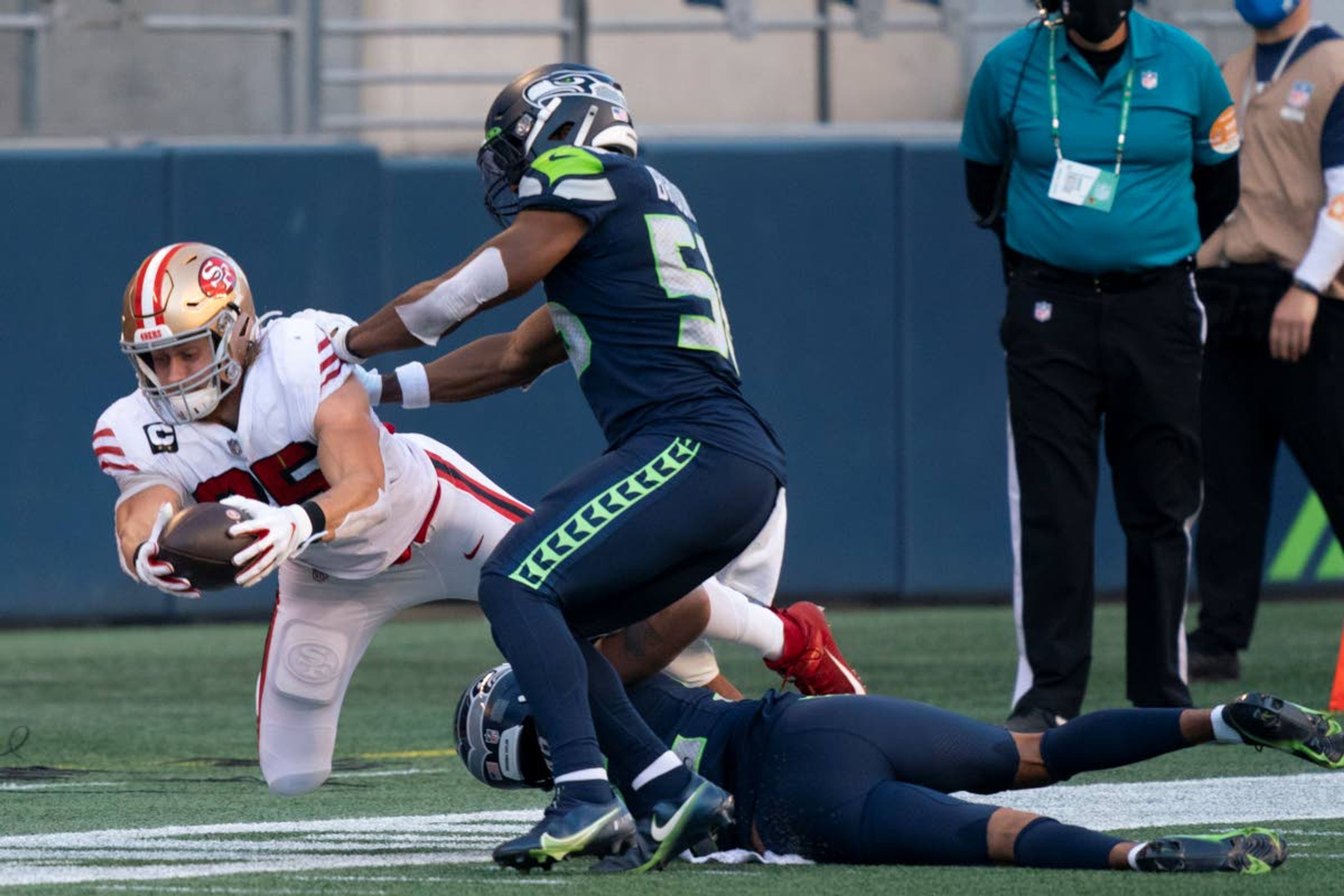 Seattle linebacker Jordyn Brooks (center) has played a major role on the Seahawks’ defense despite being a rookie.