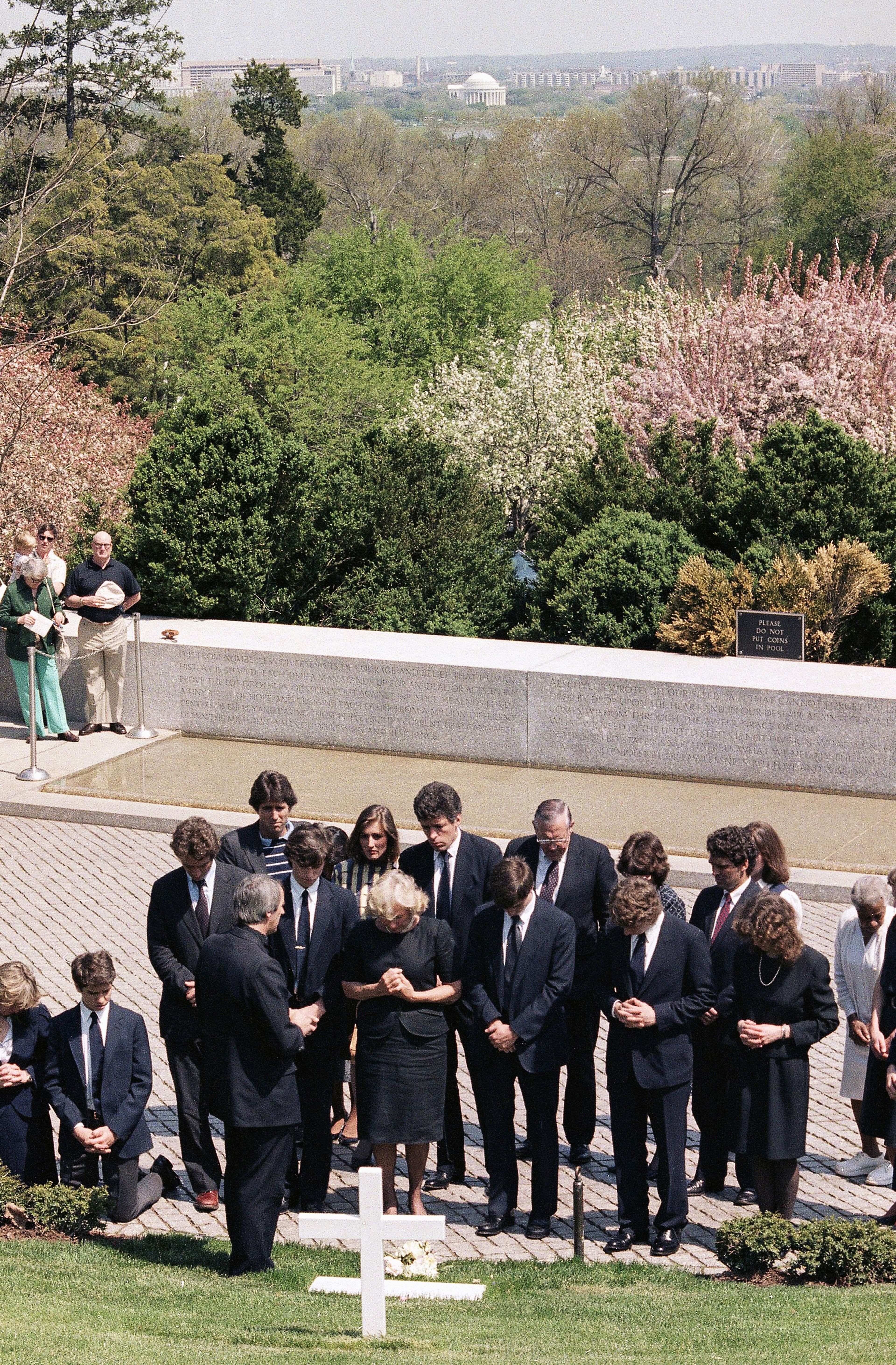 FILE - Ethel Kennedy, widow of Robert F. Kennedy, and her children pray over the grave of Robert F. Kennedy at the Arlington National Cemetery, April 26, 1984, in Arlington, Va. (AP Photo, File)