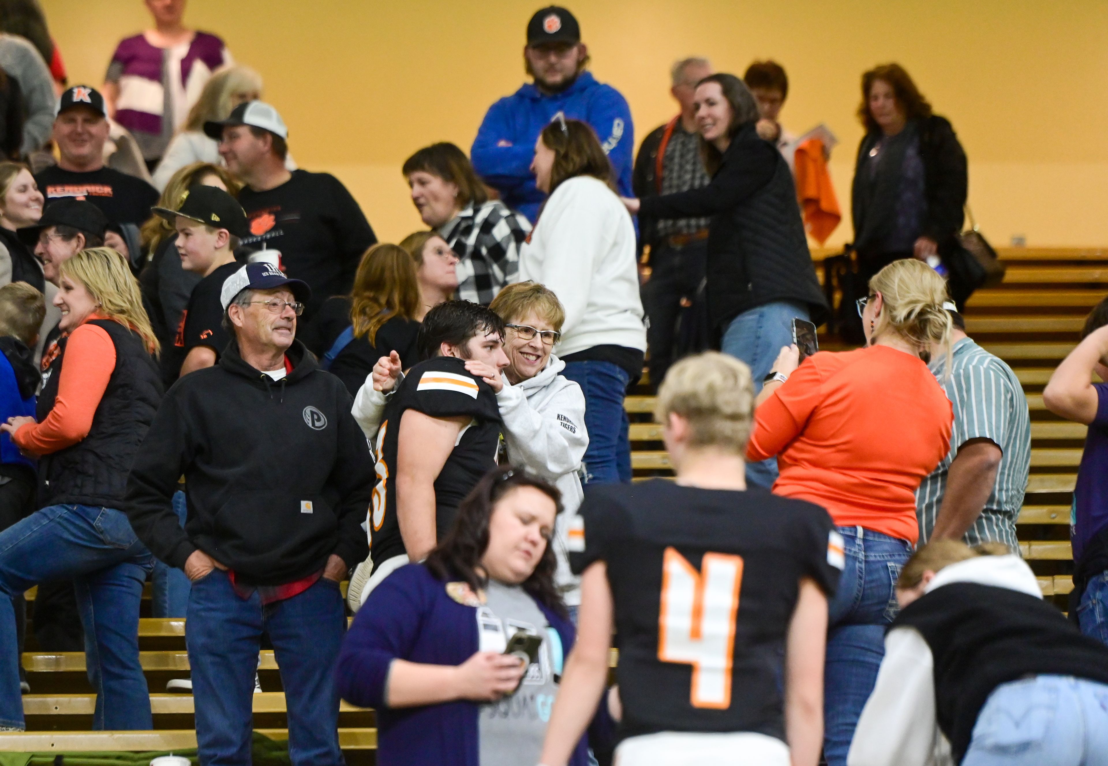 Kendrick players are greeted by loved ones after their victory over Kamiah in an Idaho Class 2A state quarterfinal game at the P1FCU Kibbie Dome in Moscow.