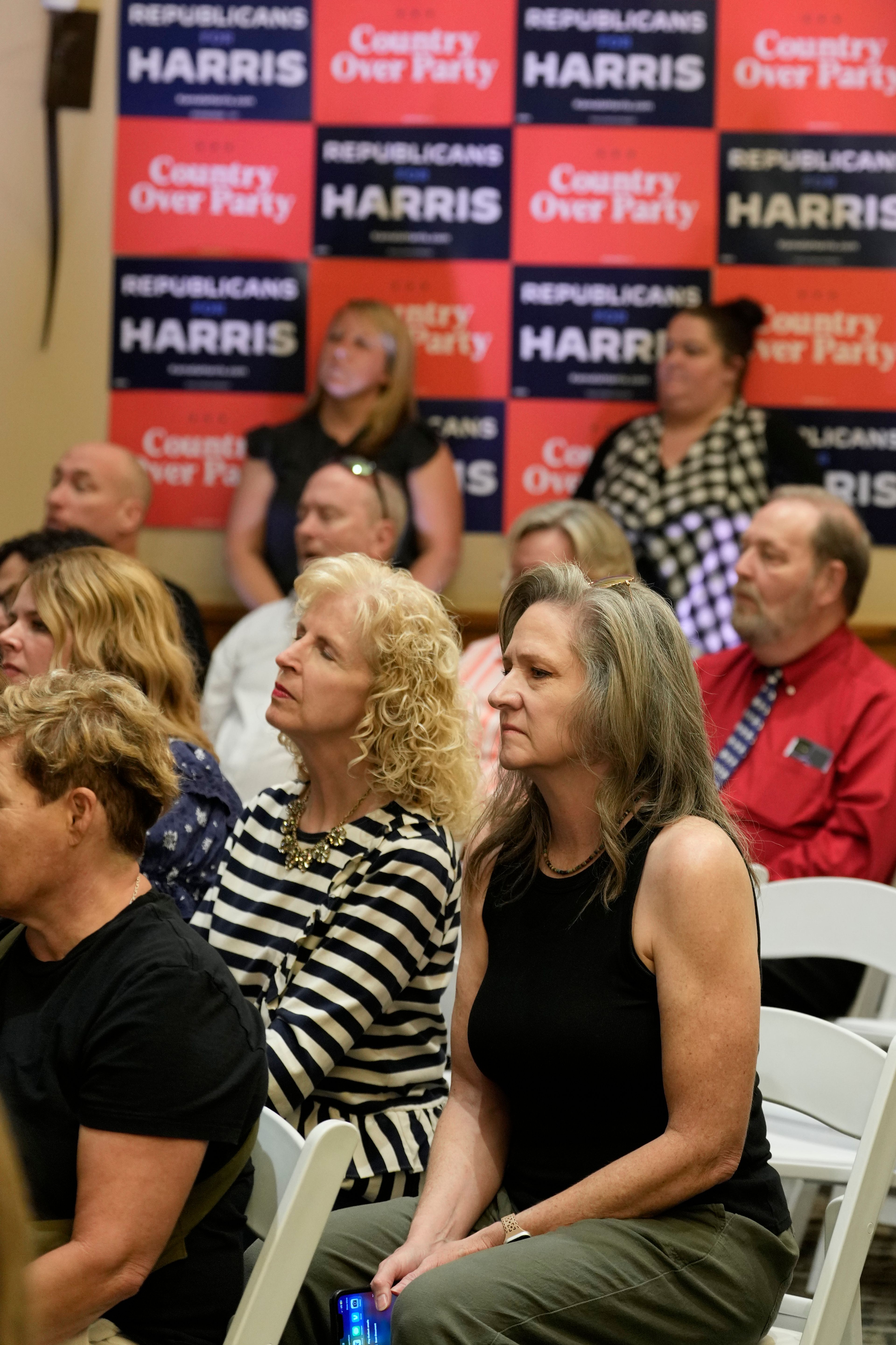 Attendees listen as Democratic presidential nominee Vice President Kamala Harris speaks at a campaign event Friday, Oct. 11, 2024, at the Grayhawk Golf Club in Scottsdale, Ariz. (AP Photo/Ross D. Franklin)