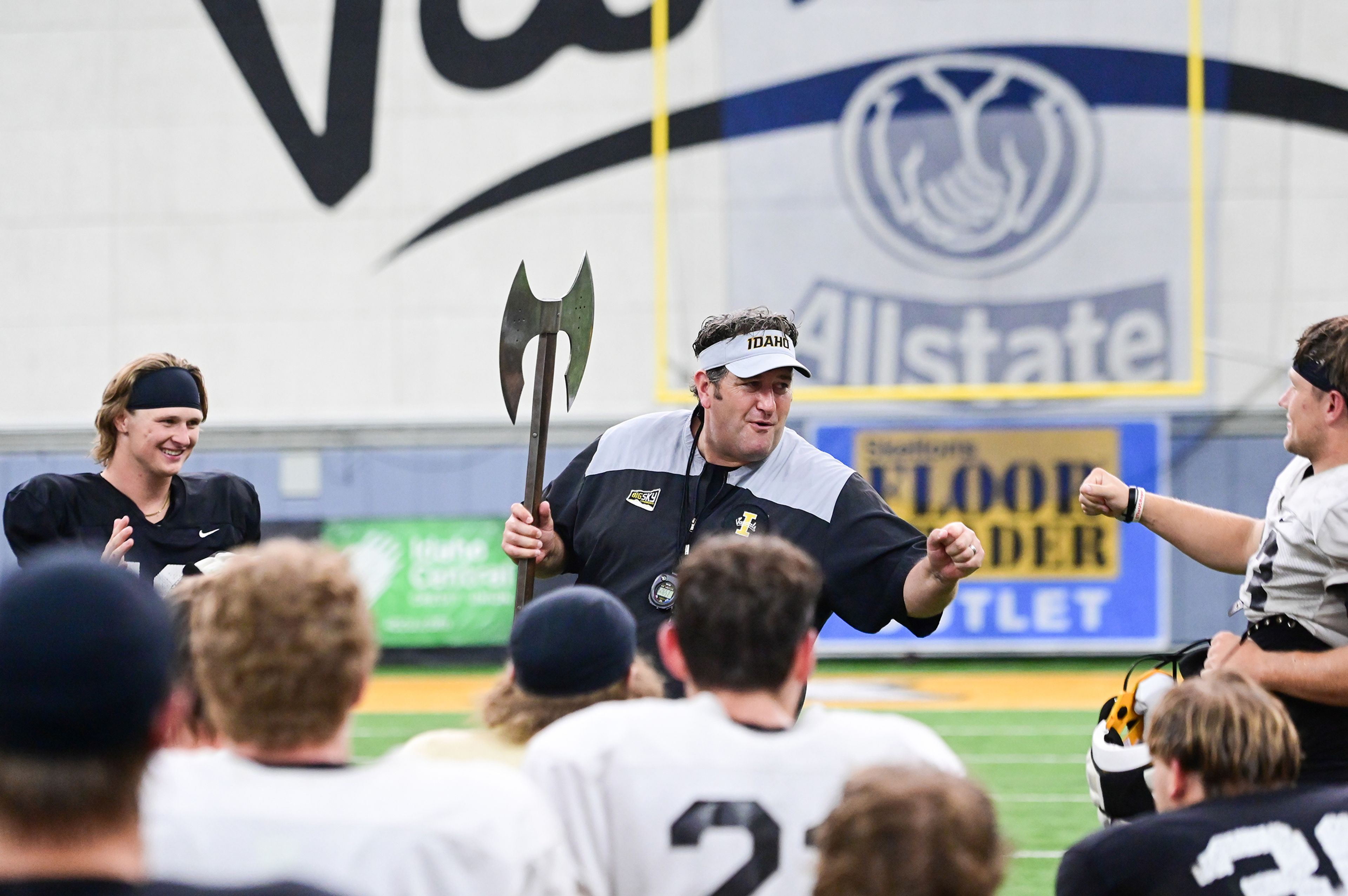 Idaho defensive back Tommy McCormick and running back Art Williams are rewarded with the battle axe by coach Jason Eck for their performance at fall camp after a team scrimmage in Moscow. 