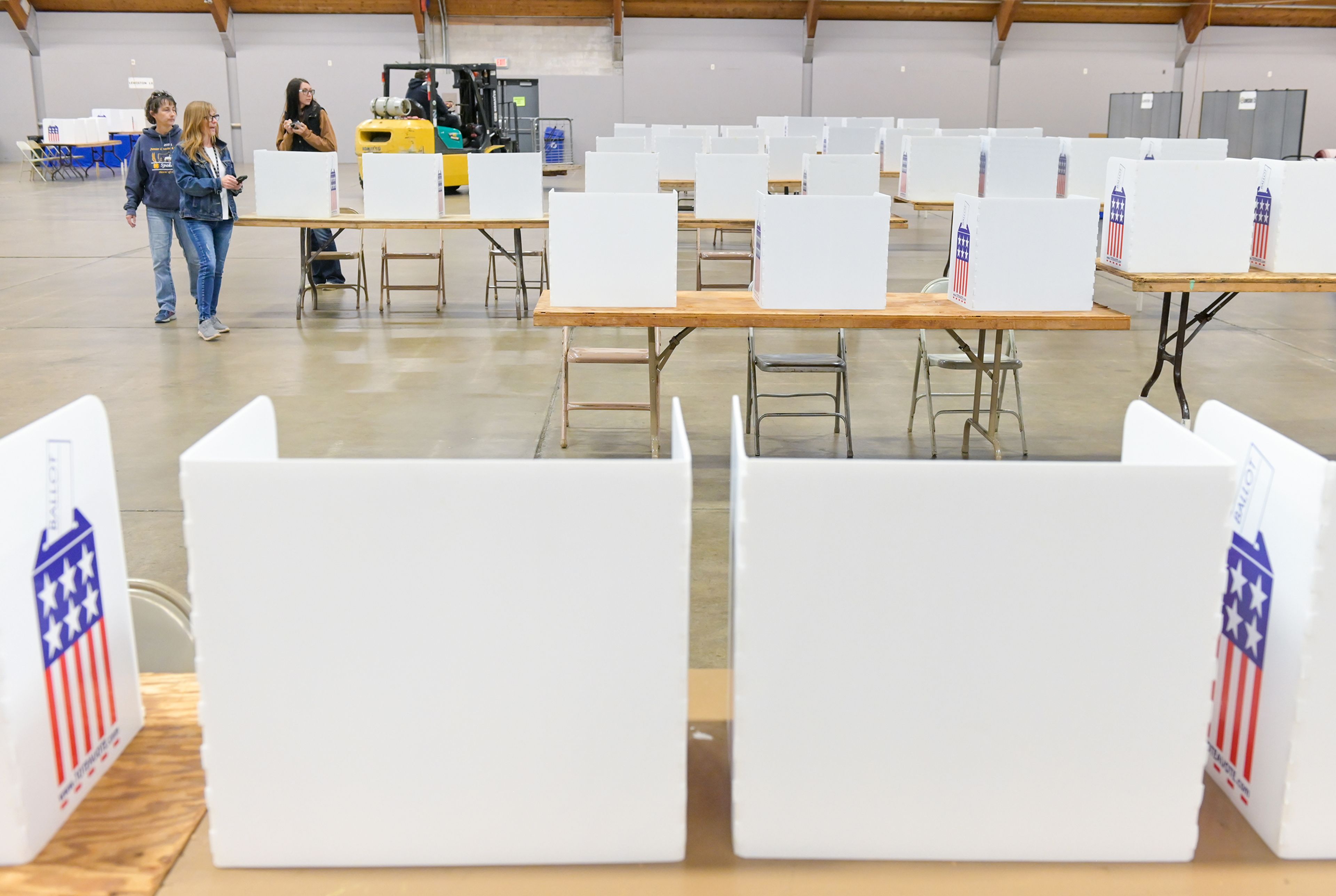 Amy Ledgerwood, left, Nez Perce County chief auditor, Patty Weeks, center, clerk and auditor, and Mckenzie Roberts, controller, walk through the polling site at the Nez Perce County Fairgrounds Monday, making note of any adjustments needed before Election Day in Lewiston.