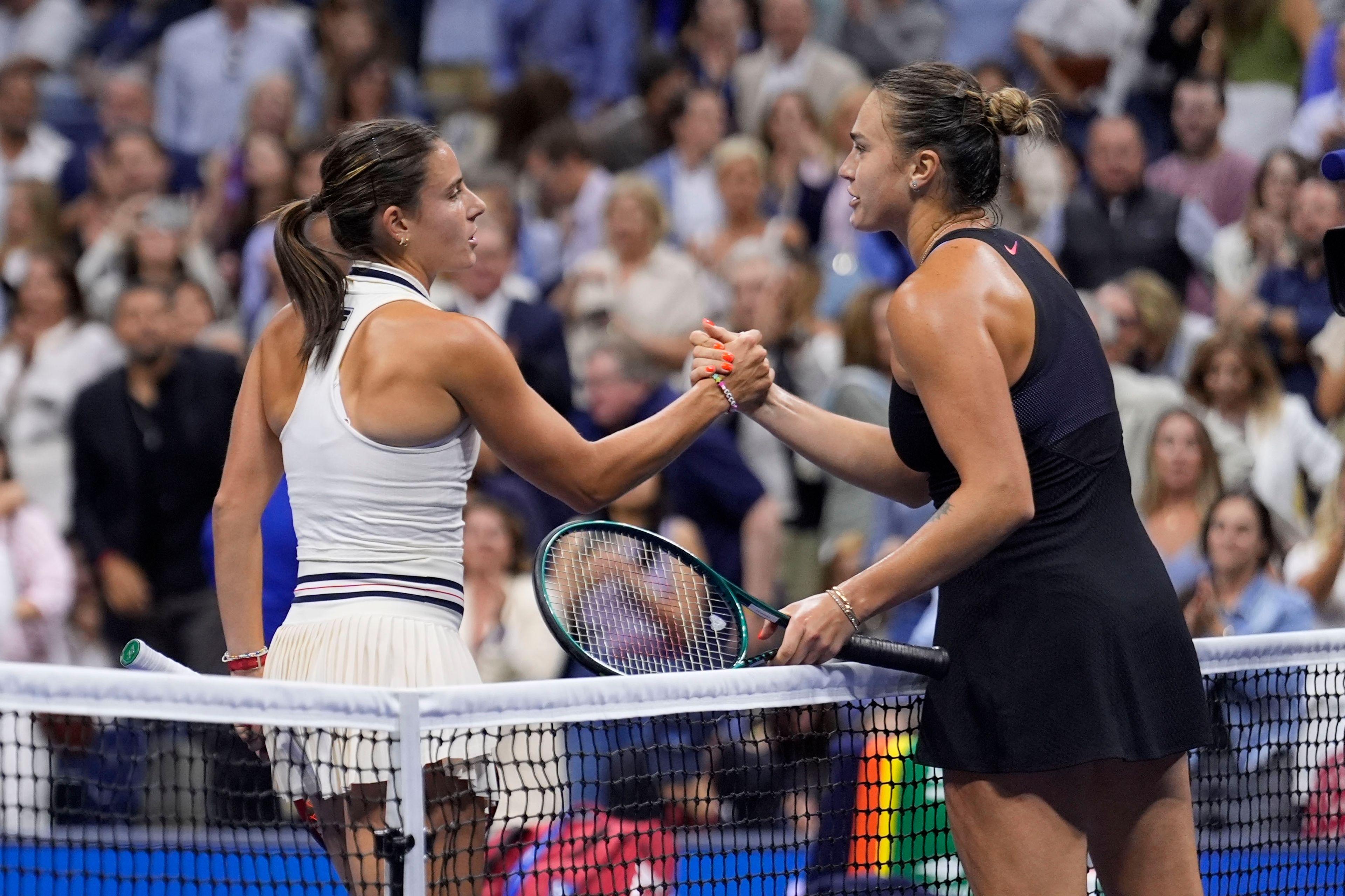 Aryna Sabalenka, right, of Belarus, shakes hands with Emma Navarro, of the United States, during the women's singles semifinals of the U.S. Open tennis championships, Thursday, Sept. 5, 2024, in New York.