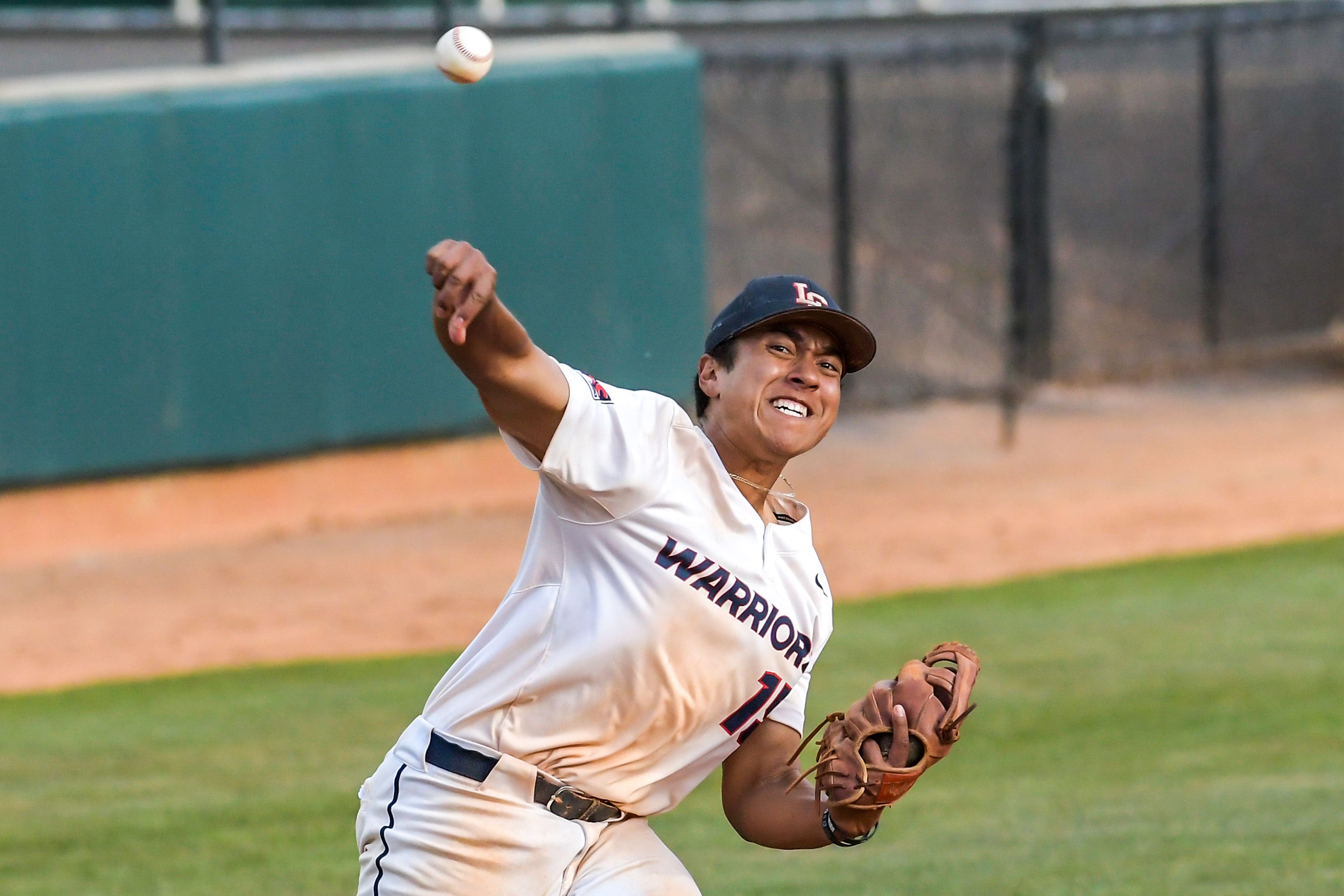 Lewis-Clark State third baseman Pu’ukani De Sa throws to first against UBC during the NAIA Opening Round on Monday at Harris Field in Lewiston.