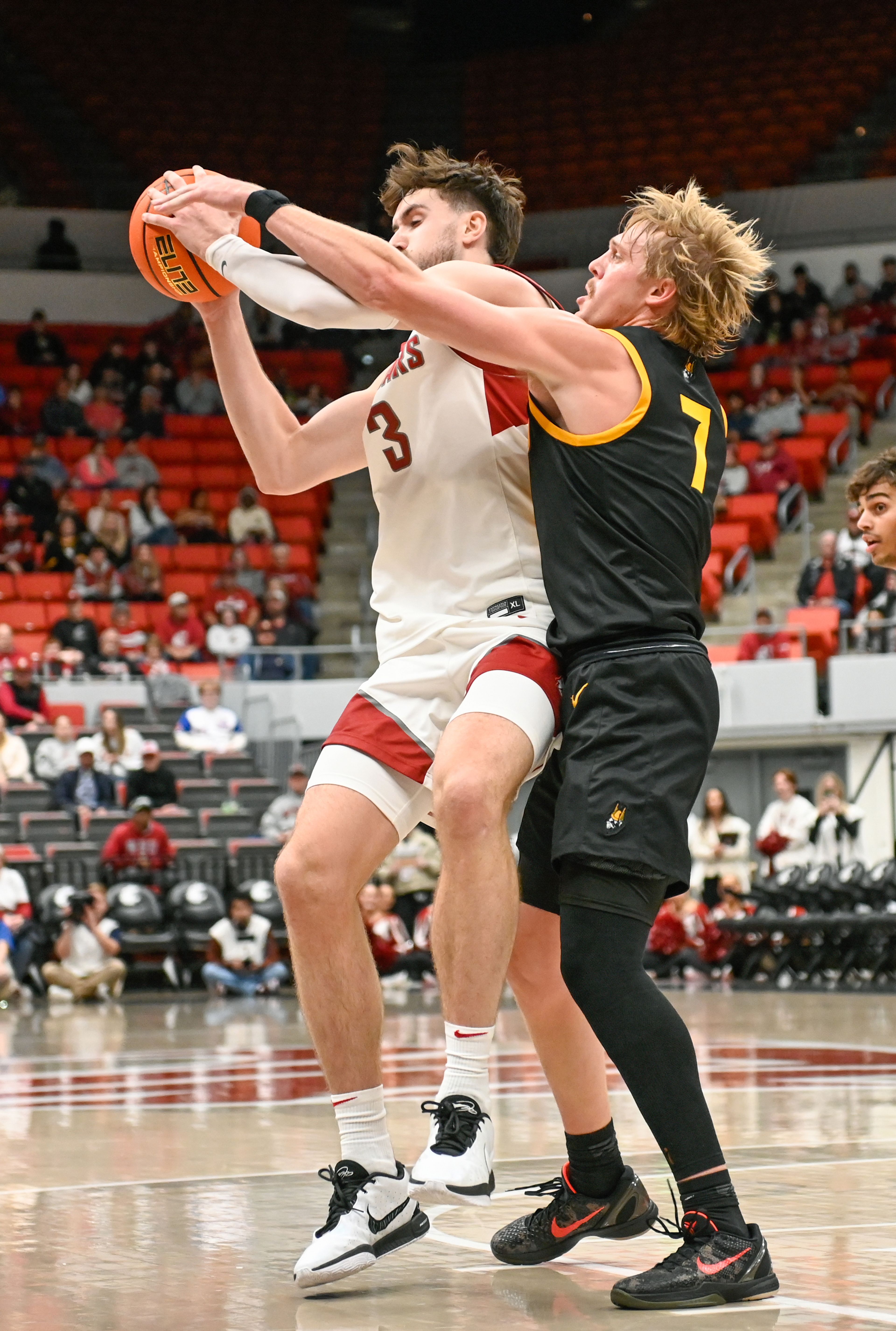 Washington State forward Ethan Price fights to keep control of the ball while being guarded Idaho guard Jack Payne during the Battle of the Palouse game Monday at Beasley Coliseum in Pullman.