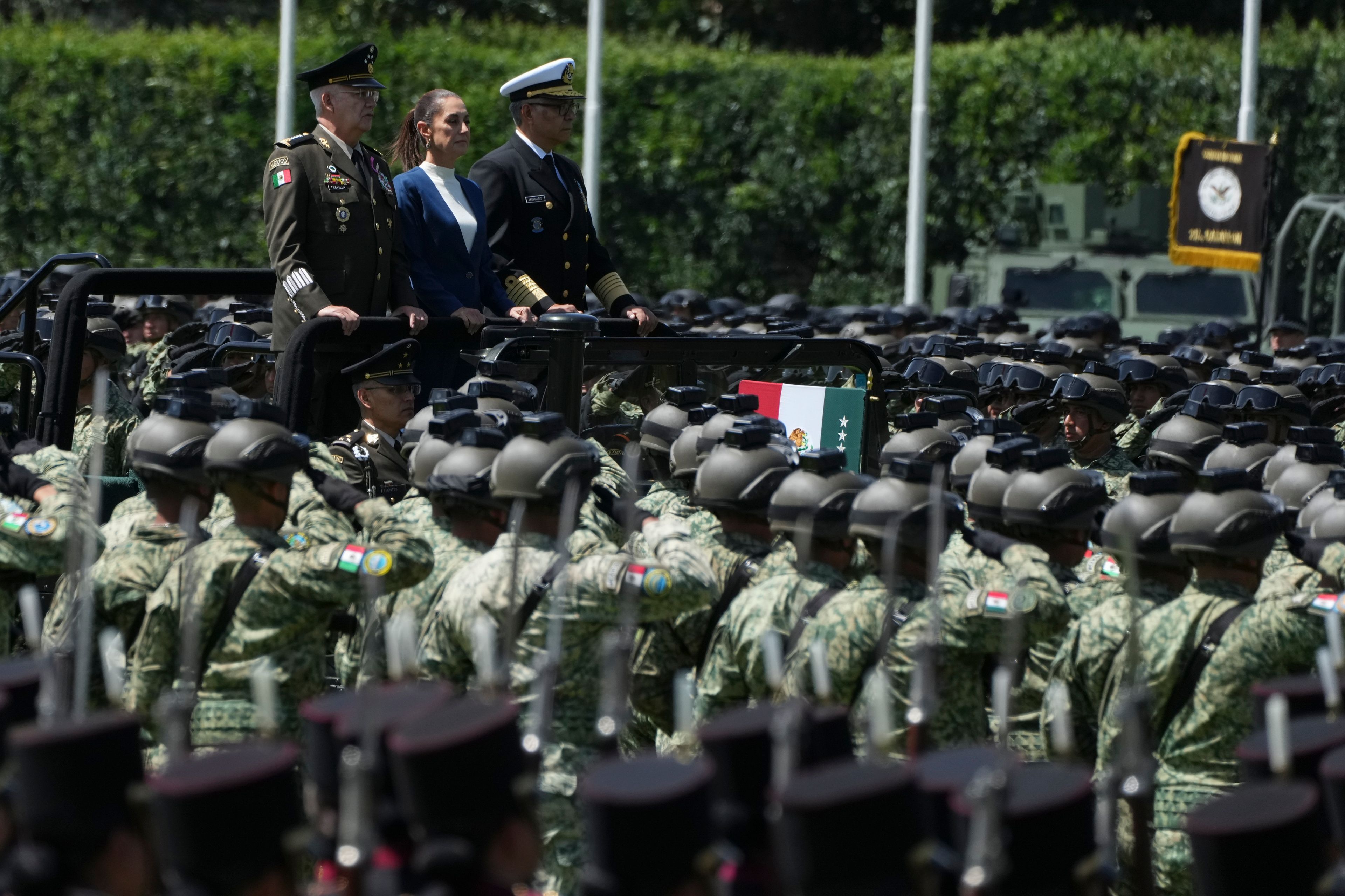 Mexican President Claudia Sheinbaum, center, reviews the troops with Defense Minister Gen. Ricardo Trevilla Trejo, left, and Navy Secretary Alt. Raymundo Pedro Morales at Campo Marte in Mexico City, Thursday, Oct. 3, 2024. (AP Photo/Fernando Llano)