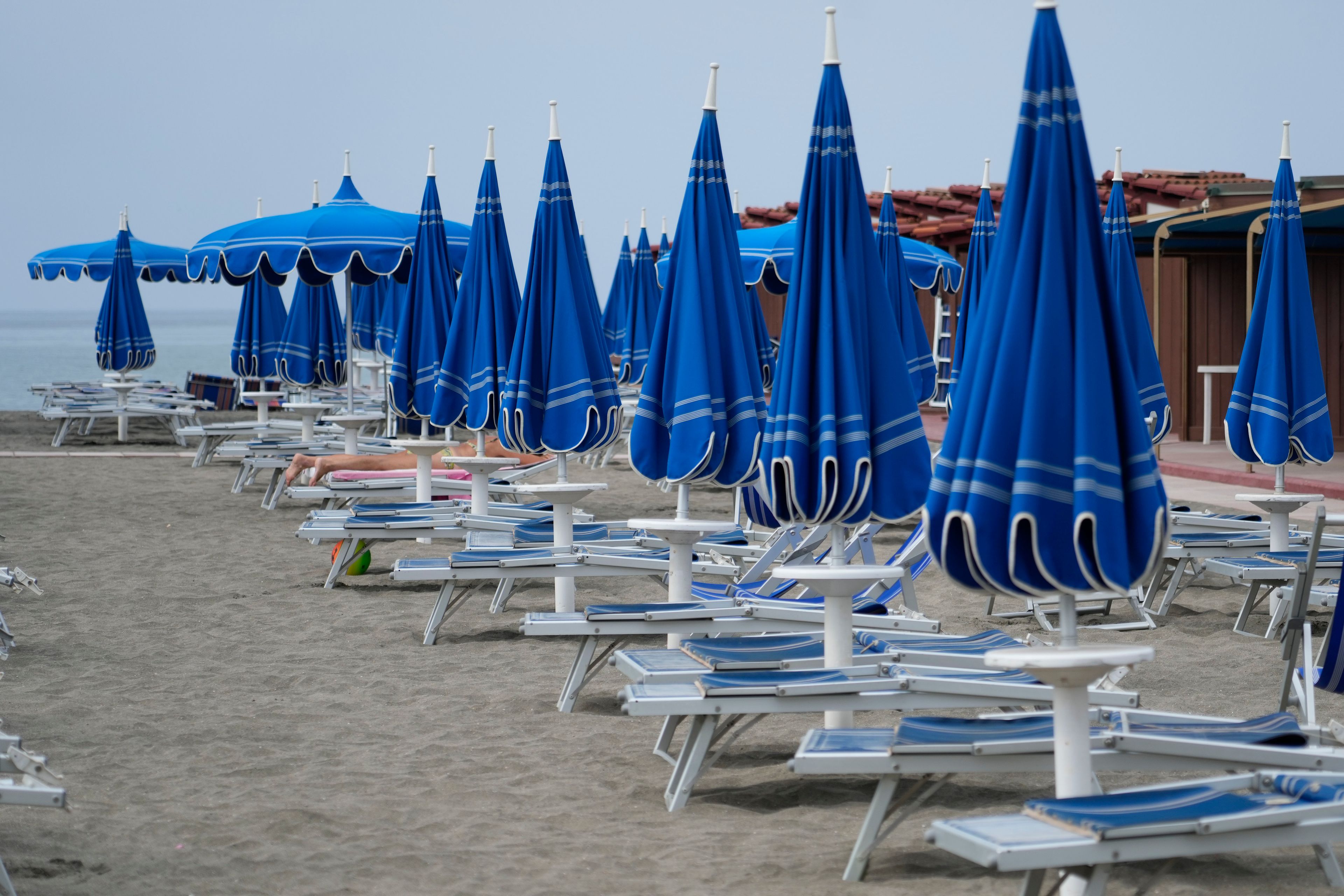 Umbrellas and sun beds are set at the Venezia beach establishment in Ostia, near Rome, Friday, Aug. 16, 2024.