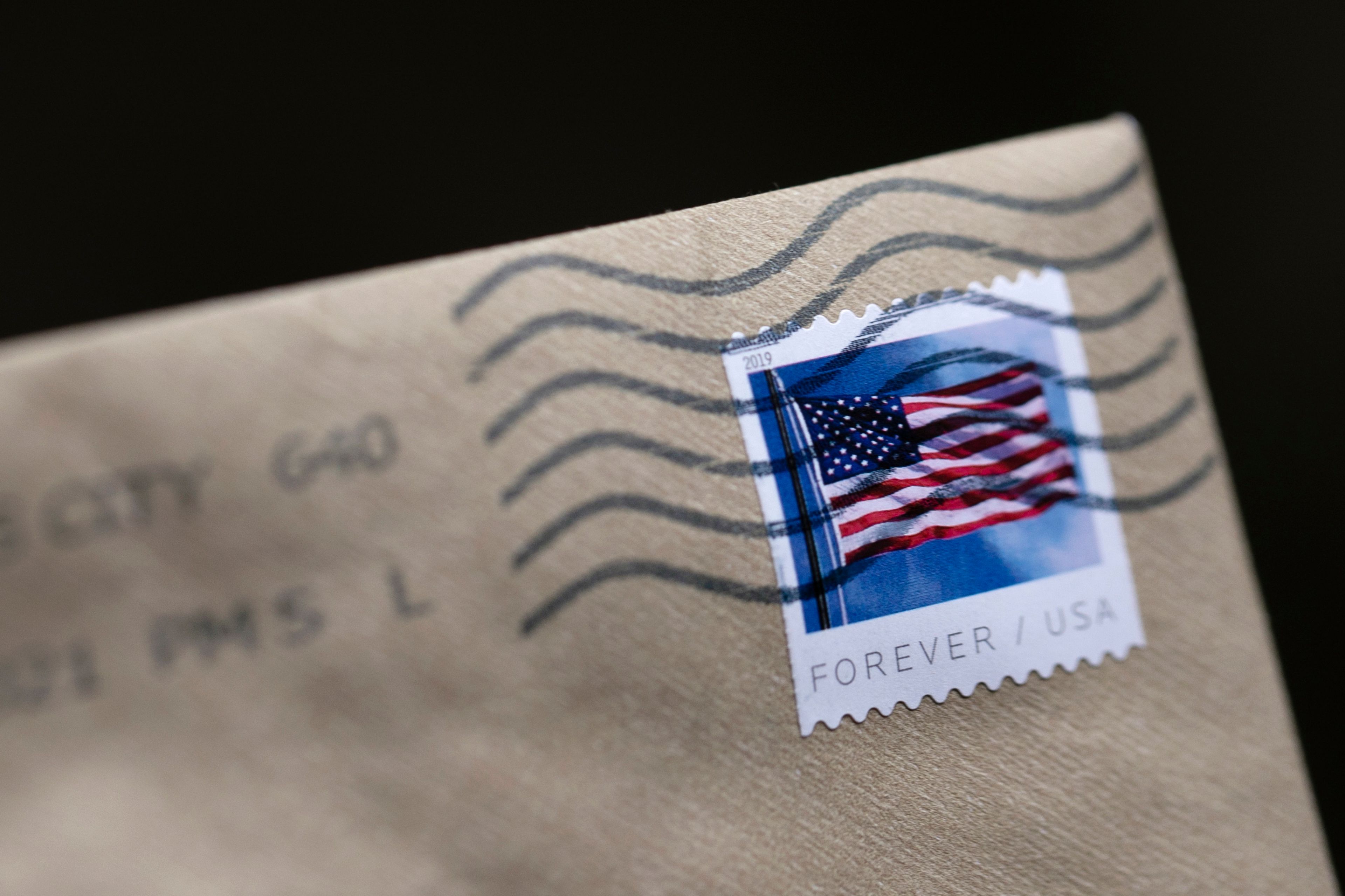 FILE - A stamp is shown on an envelope Friday, May 28, 2021, in Washington. When you receive an email or mail notice inviting you to join a class-action lawsuit, or notifying you that you’ve been automatically included, it might give you pause. Is it worth the small reward — usually under $20 — to give up your rights to sue individually? (AP Photo/Jenny Kane, File)