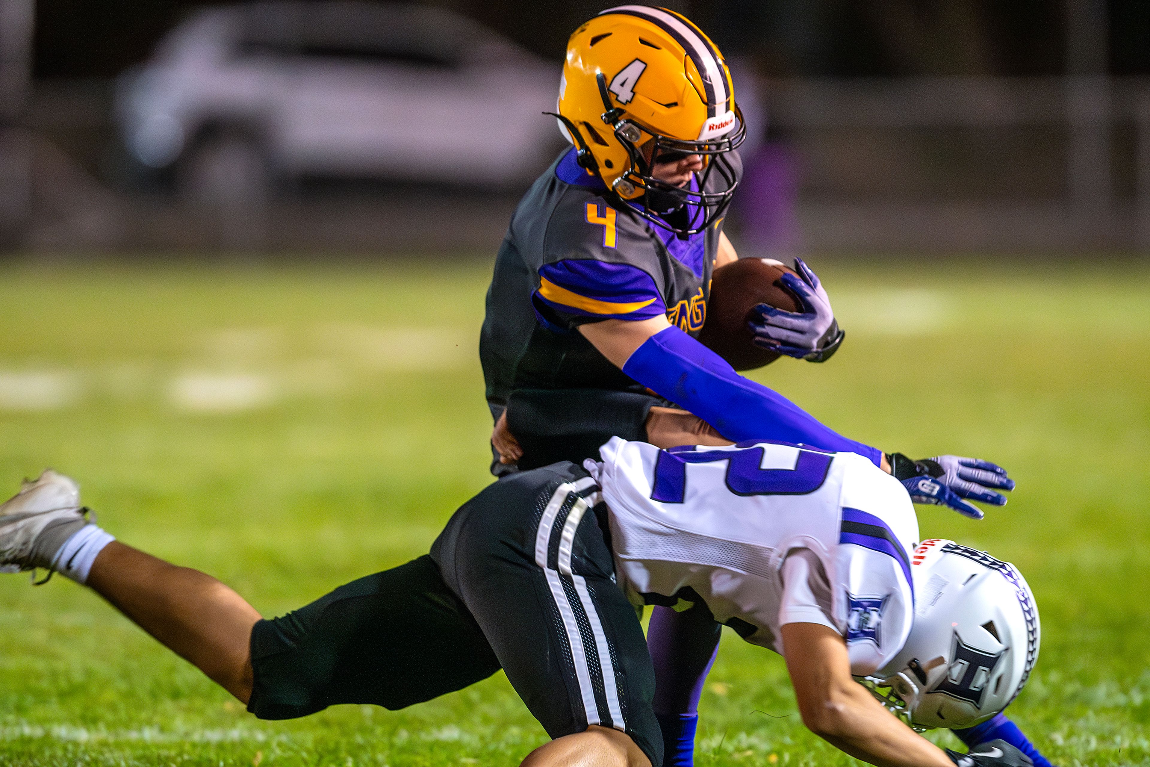 Lewiston running back Noah Carpenter avoids a tackle from Hermiston linebacker Kole Mikami during a nonconference game at Bengal Field Friday in Lewiston.,