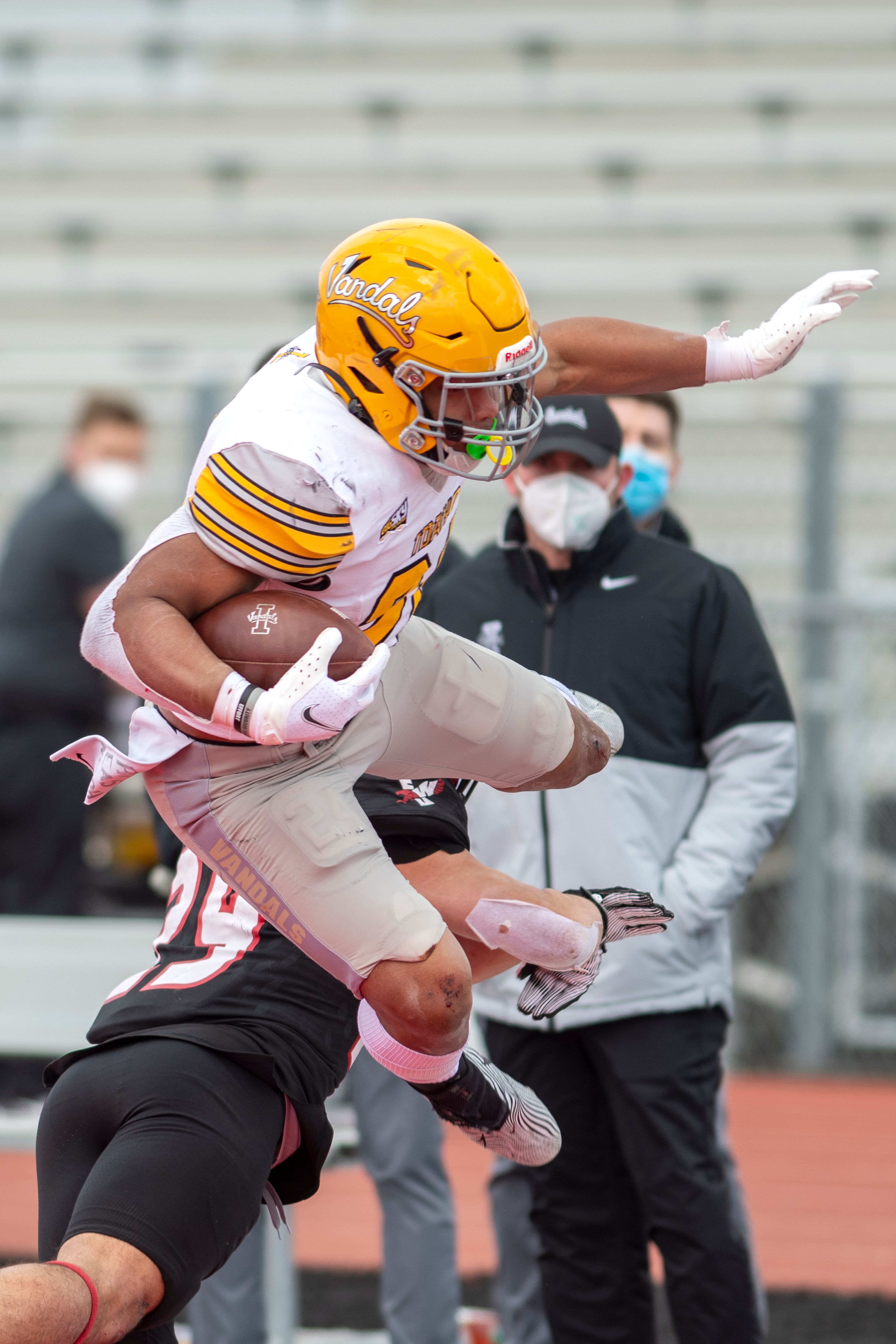 Idaho running back Roshaun Johnson (24) hurdles Eastern Washington defensive back Anthany Smith (29) during the third quarter of a Big Sky Conference matchup at Roos Field on Saturday afternoon. Eastern Washington defeated Idaho 38-31.