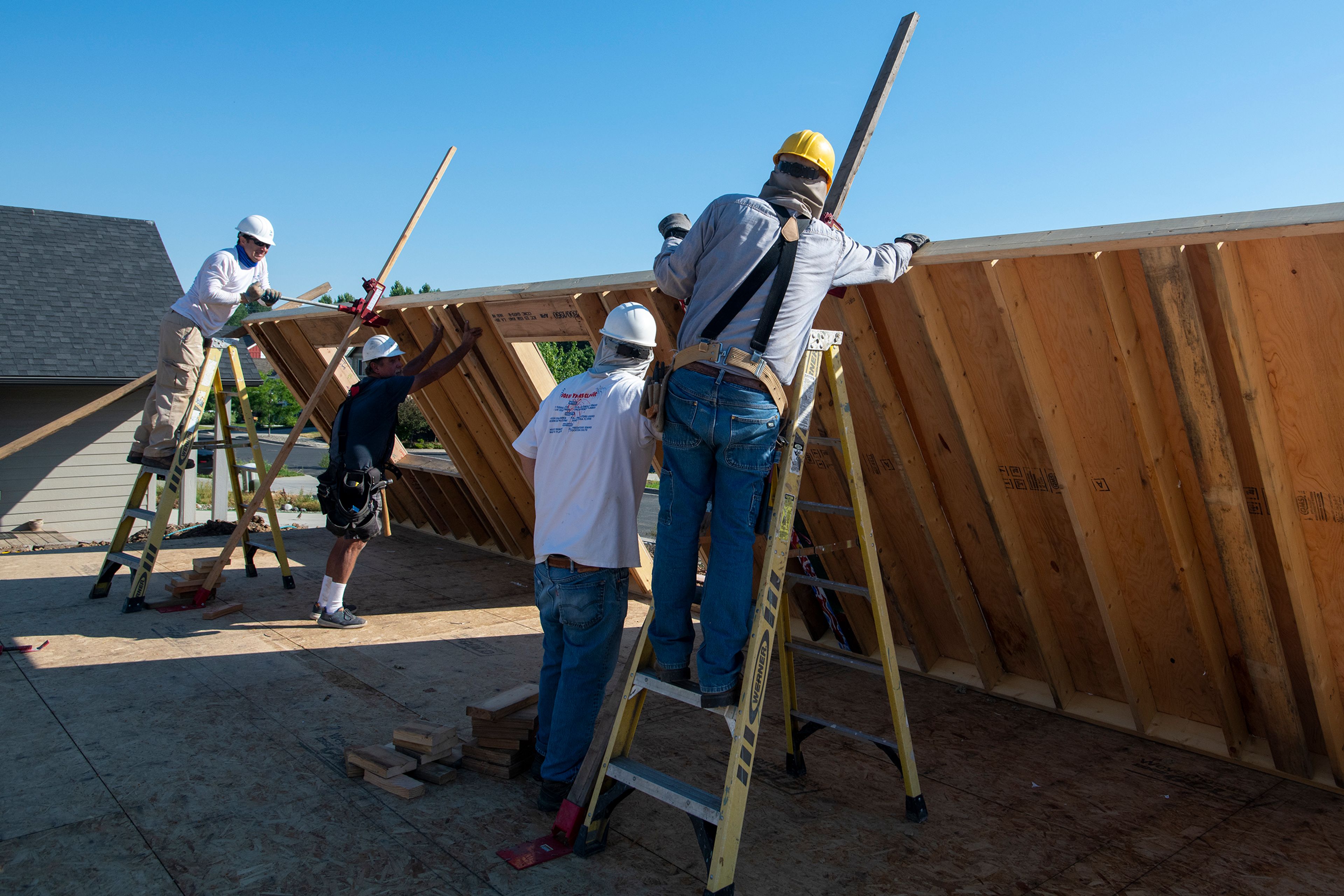 Volunteers from Palouse Habitat for Humanity raise a wall for a home being constructed on Leepike Court in Moscow.