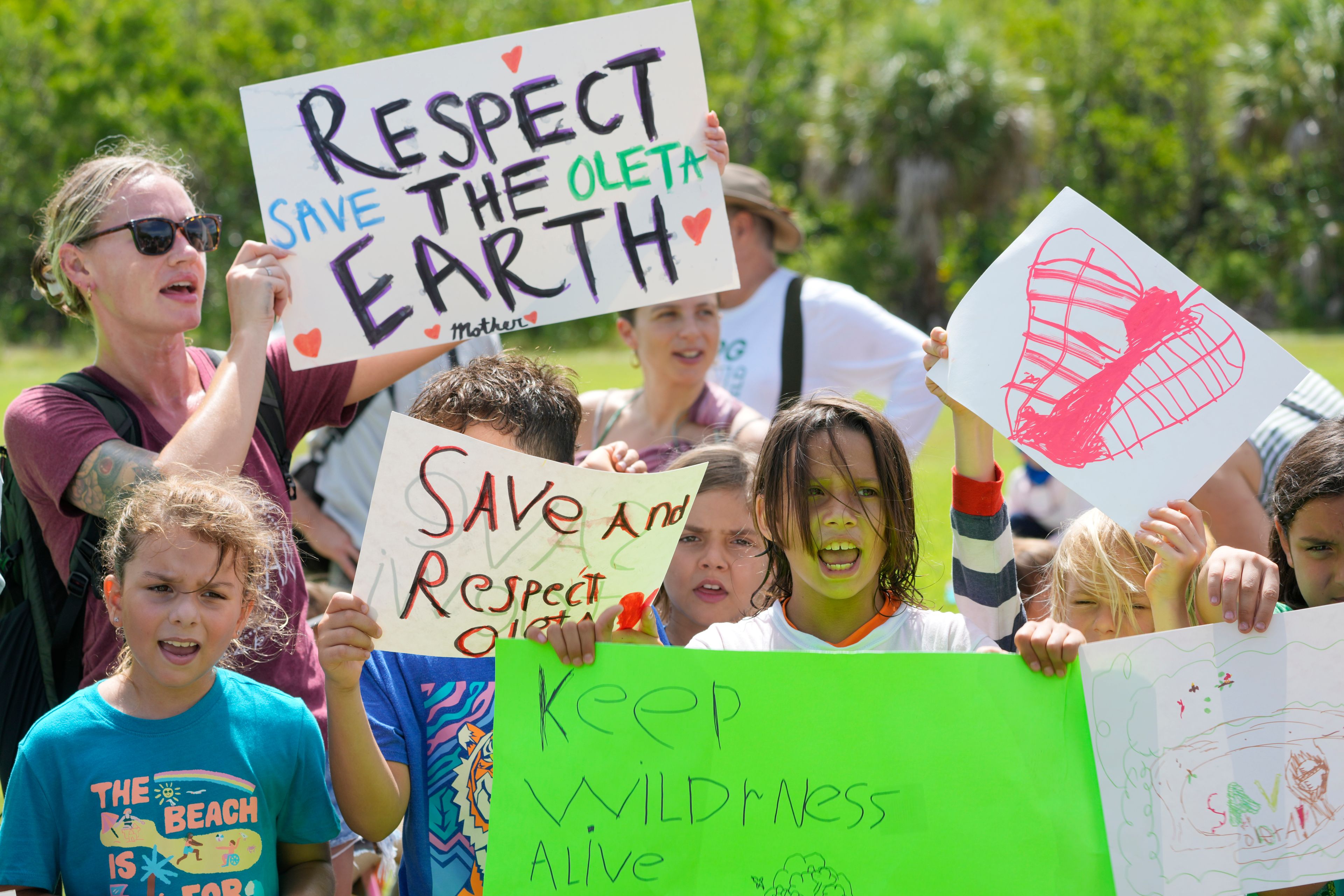 Protesters chant against Gov. Ron DeSantis' plan to develop state parks with business ventures such as golf courses, pickleball courts and large hotels, during a demonstration at Oleta River State Park, Tuesday, Aug. 27, 2024, in North Miami Beach, Fla.