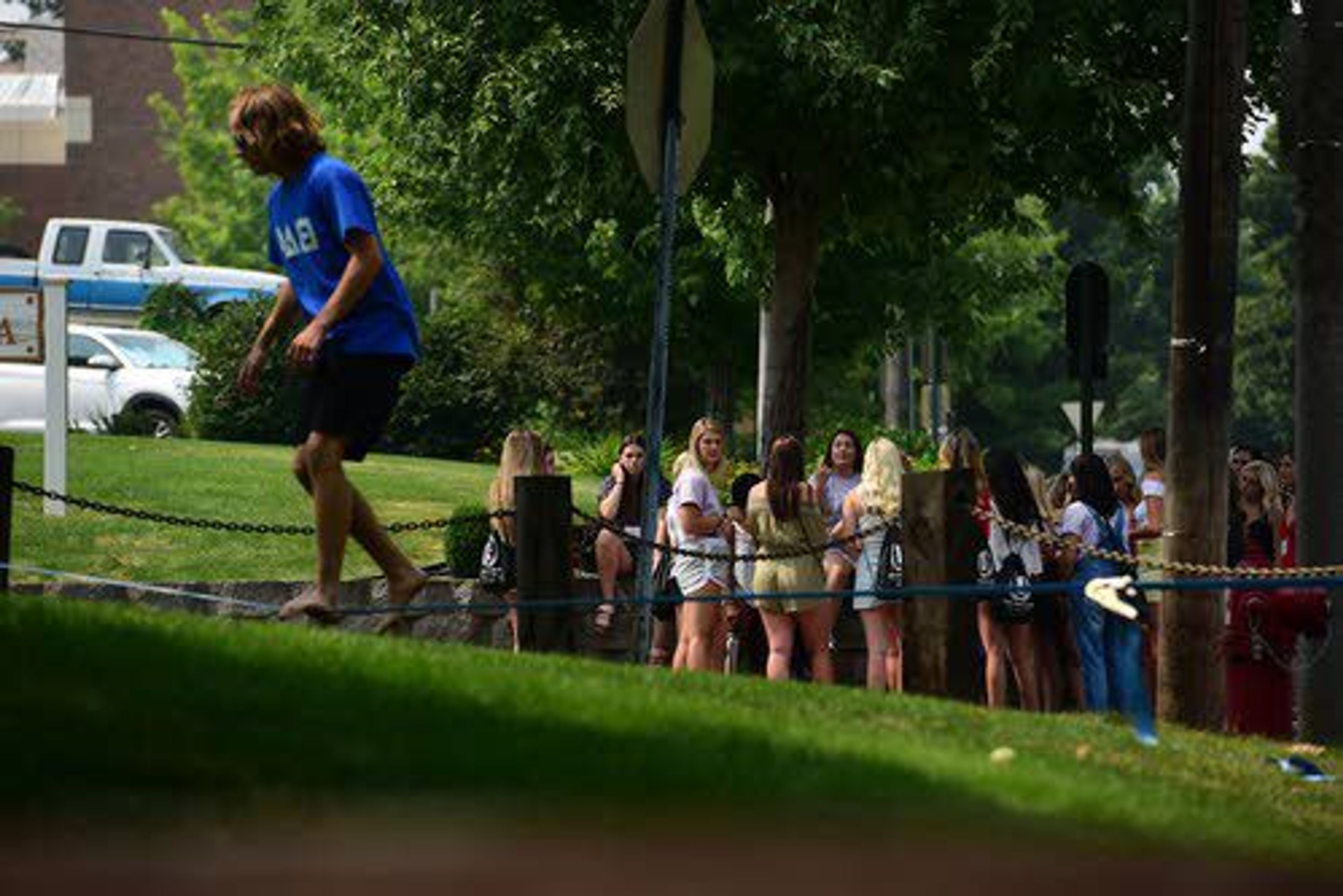 Steven Haener of Boise traverses a slackline in front of a group of female University of Idaho students going through Greek Rush Week on Friday in Moscow. Friday marked the second day of Fall Formal Recruitment at the school as students begin to move into housing prior to classes starting Aug. 21.