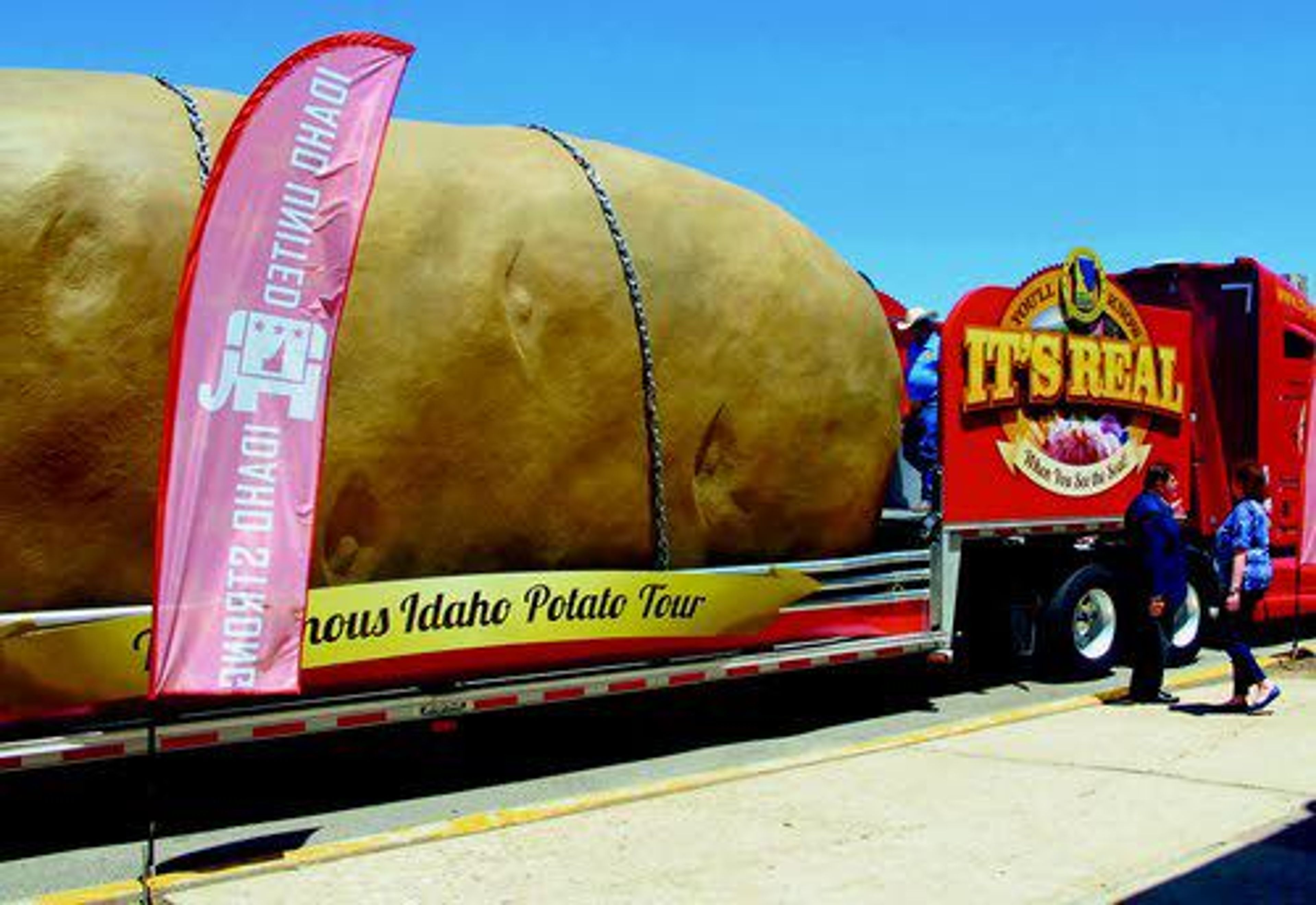 Delegates to the state Republican Party Convention pose with an Idaho potato the size of a big rig outside the GOP convention in Pocatello on Thursday.