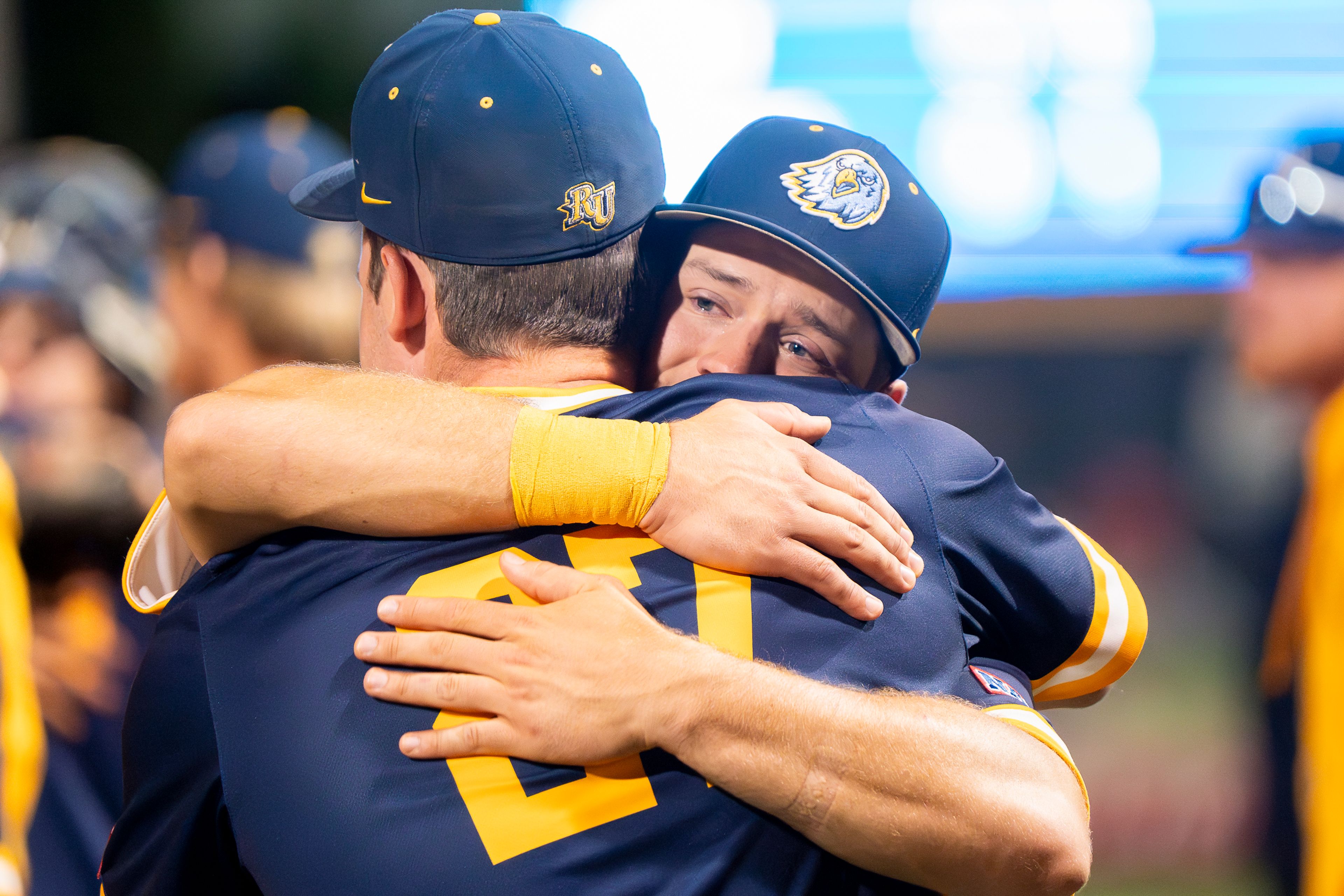 Reinhardt’s Tucker Zdunich, right, hugs Hunter Paulsen after being eliminated following their Game 18 loss to Tennessee Wesleyan in the NAIA World Series on Thursday at Harris Field in Lewiston.