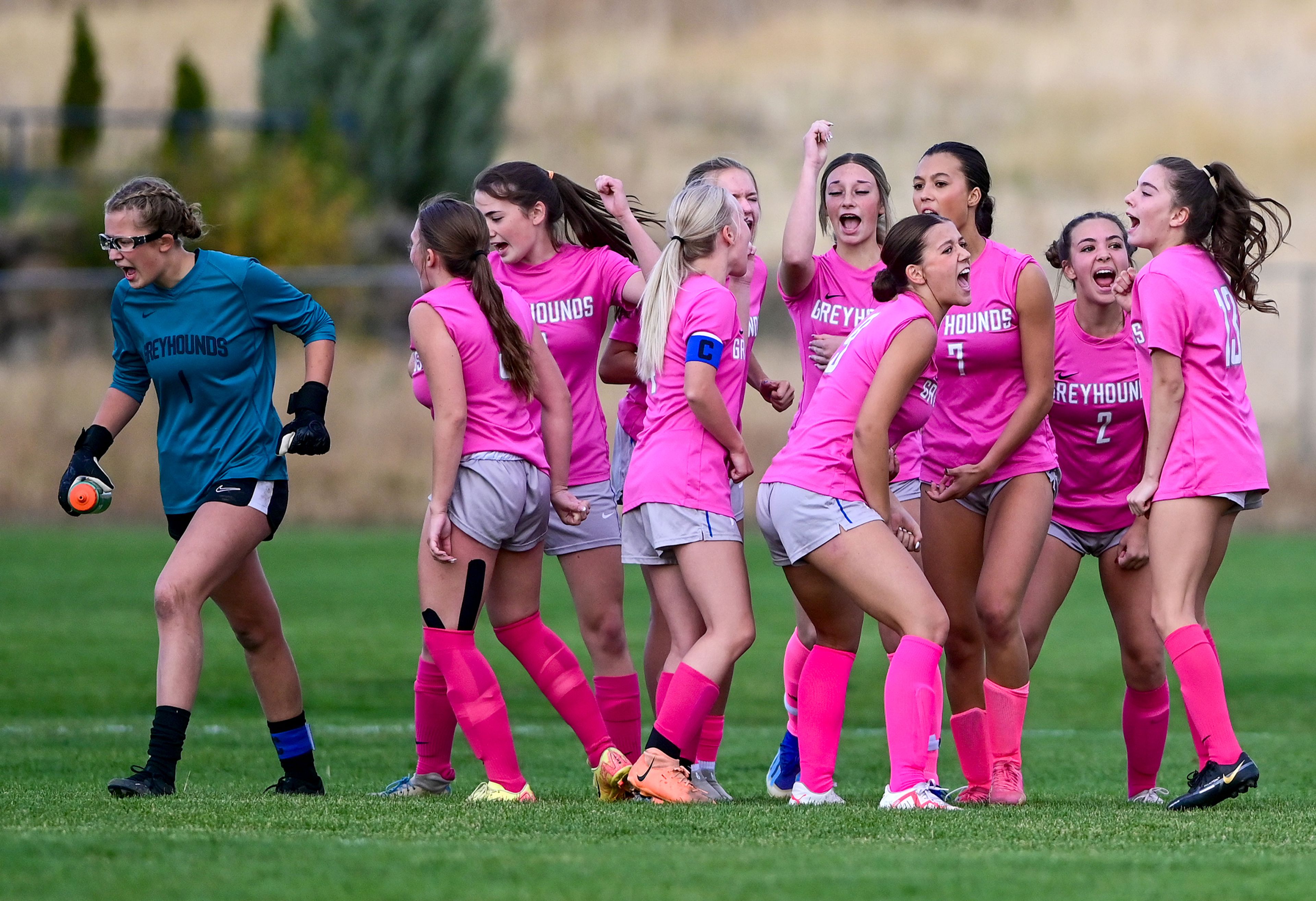 Pullman players cheer as they exit a huddle before the start of the second half of a game against Deer Park Thursday in Pullman.,