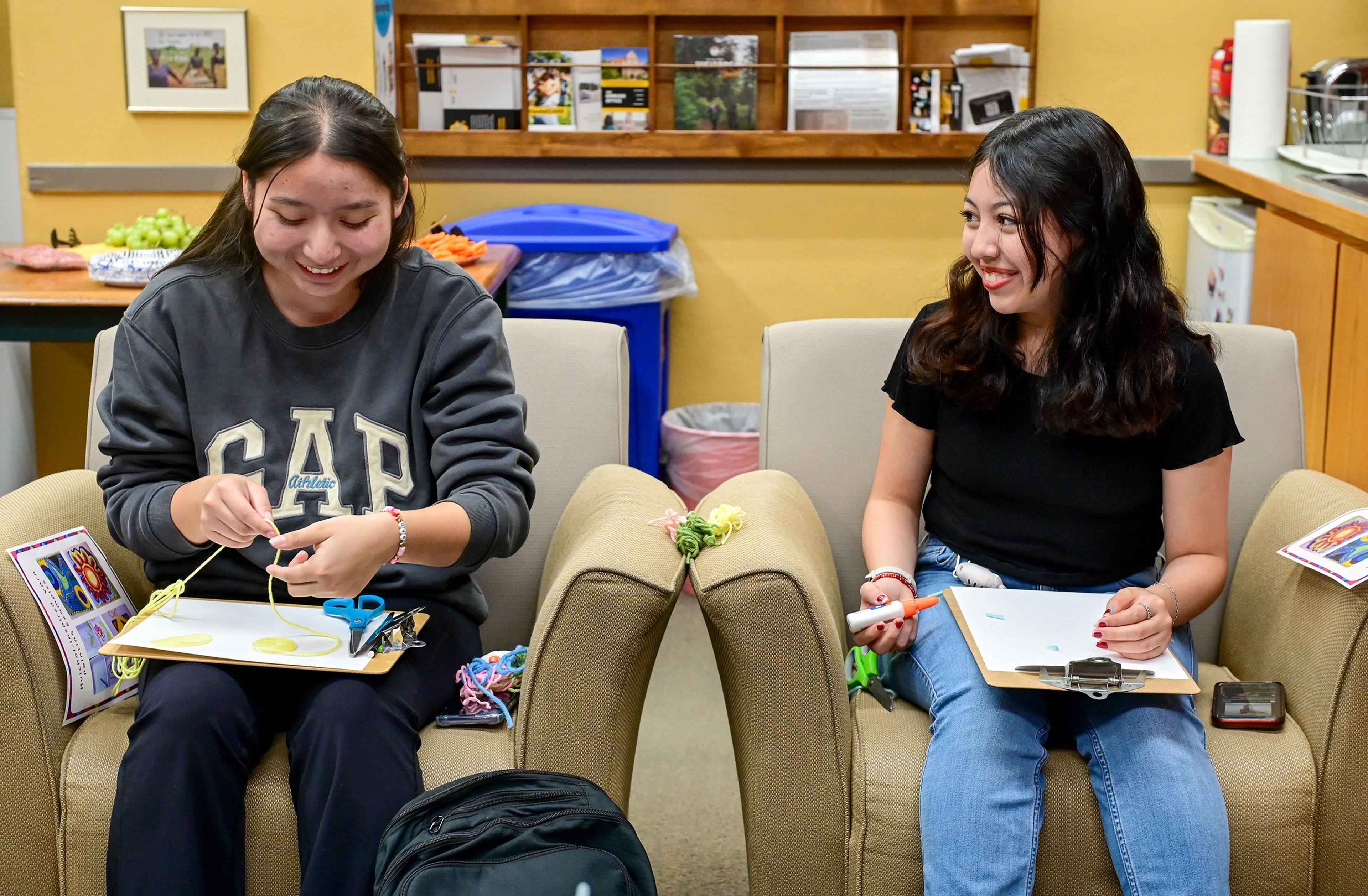 First year University of Idaho students Lizvet Vega, left, and Itzel Araujo chat Friday as they work on yarn art inspired by Huichol, an indigenous people of Mexico, in Moscow. The event, held at the campus Womens Center, is part of the programming to celebrate Latinx Heritage Month with the UI Office of Multicultural Affairs.