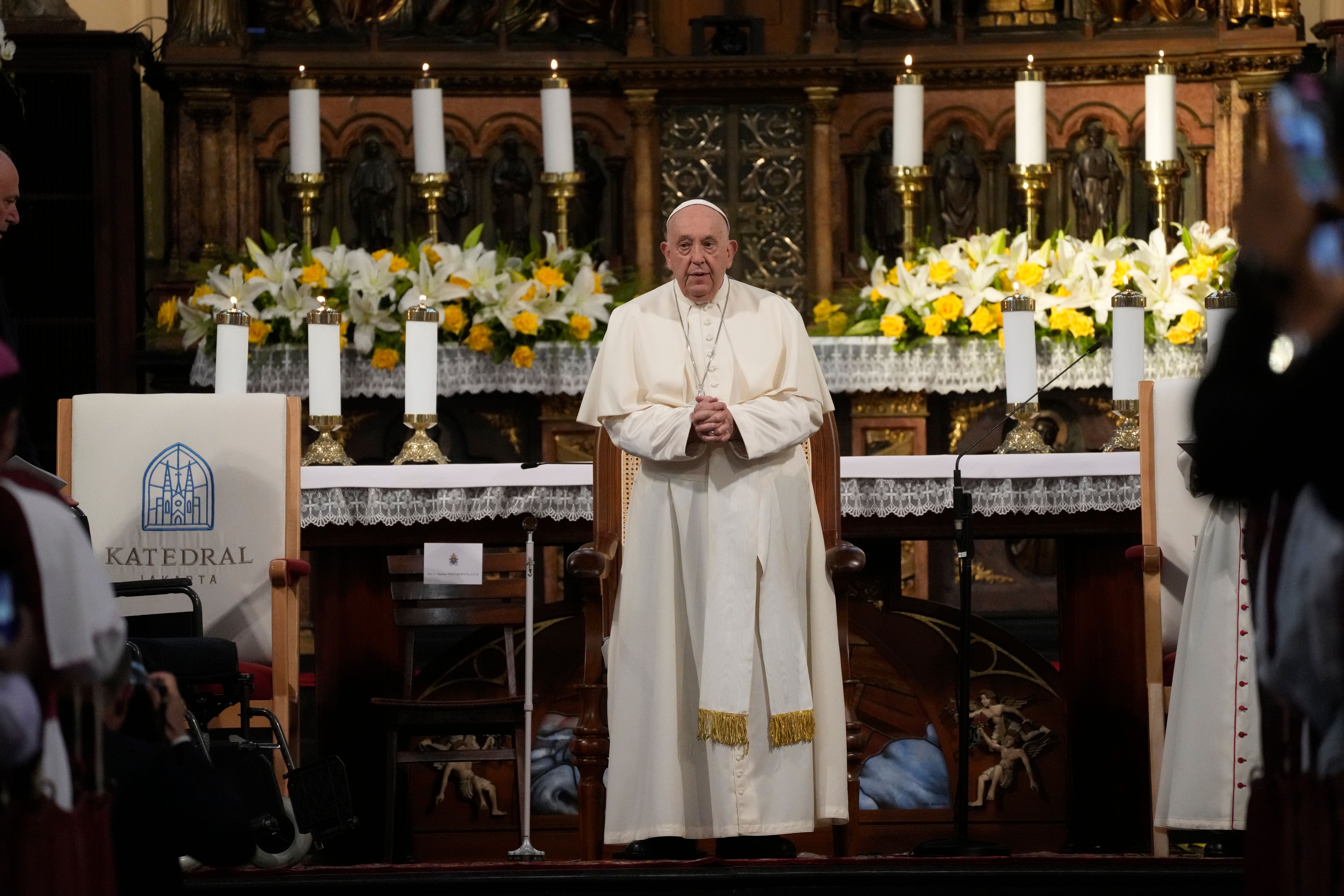 Pope Francis attends a meeting with Catholic priests, nuns and seminarians inside the Cathedral of Our Lady of the Assumption in Jakarta, Wednesday, Sept. 4, 2024. Pope Francis urged Indonesia to live up to its promise of "harmony in diversity" and fight religious intolerance on Wednesday, as he set a rigorous pace for an 11-day, four-nation trip through tropical Southeast Asia and Oceania that will test his stamina and health.