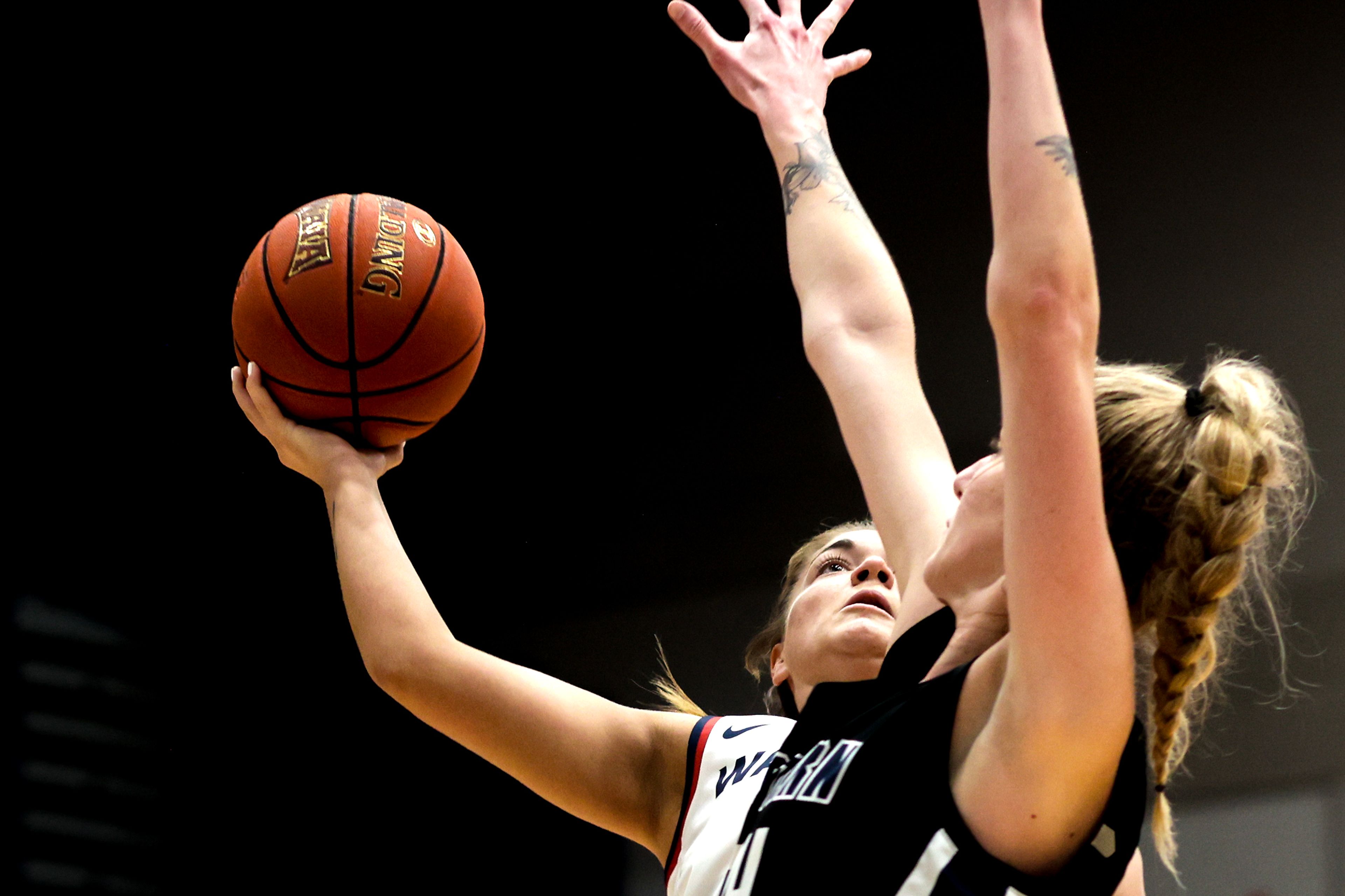 Lewis-Clark State guard Payton Hymas prepares to shoot the ball as Eastern Oregon forward Shaelie Burgess defends during a Cascade Conference game Friday at Lewis-Clark State College.