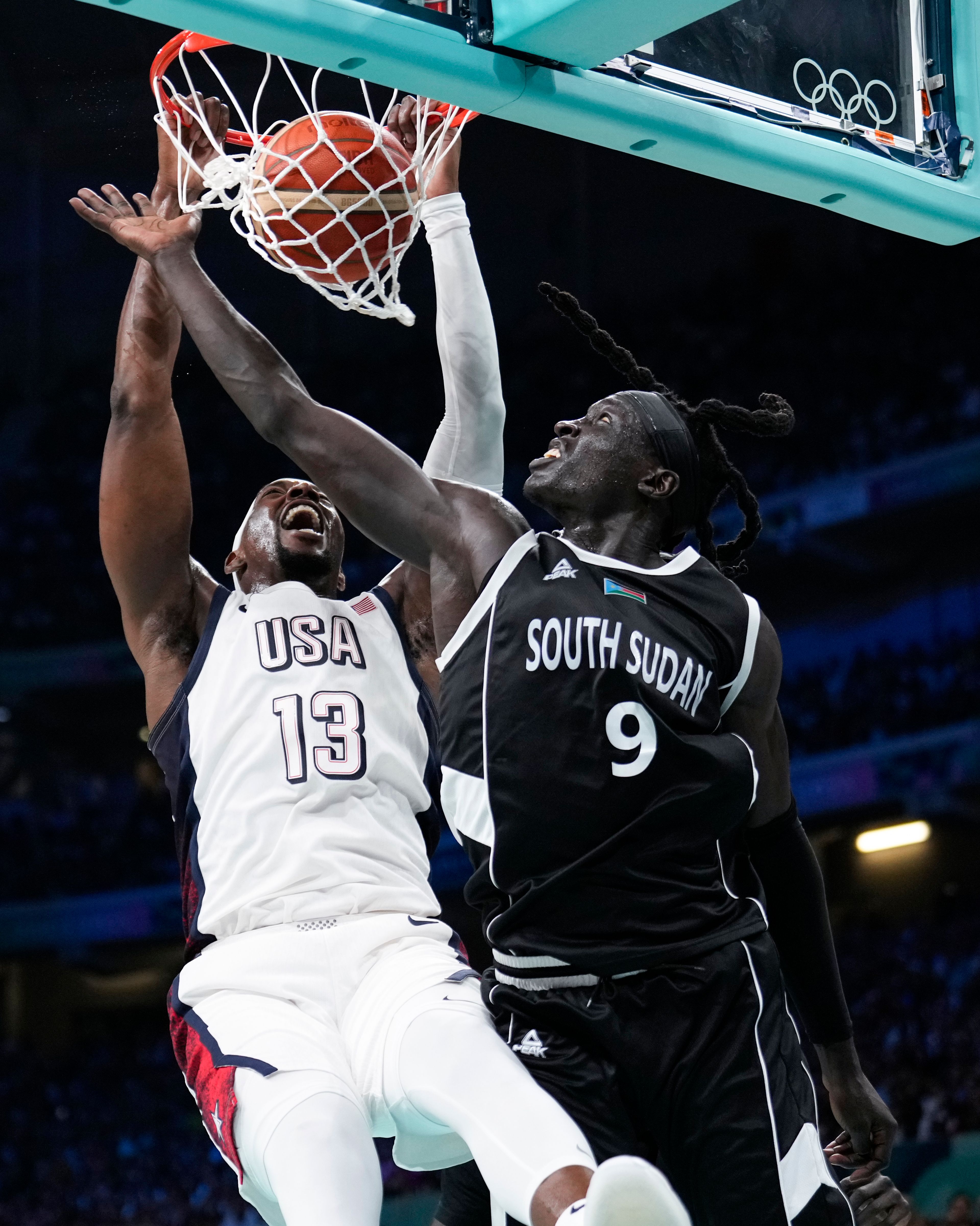 Bam Adebayo, of the United States, get a basket over Wenyen Gabriel, of South Sudan, in a men's basketball game at the 2024 Summer Olympics, Wednesday, July 31, 2024, in Villeneuve-d'Ascq, France. (AP Photo/Mark J. Terrill)