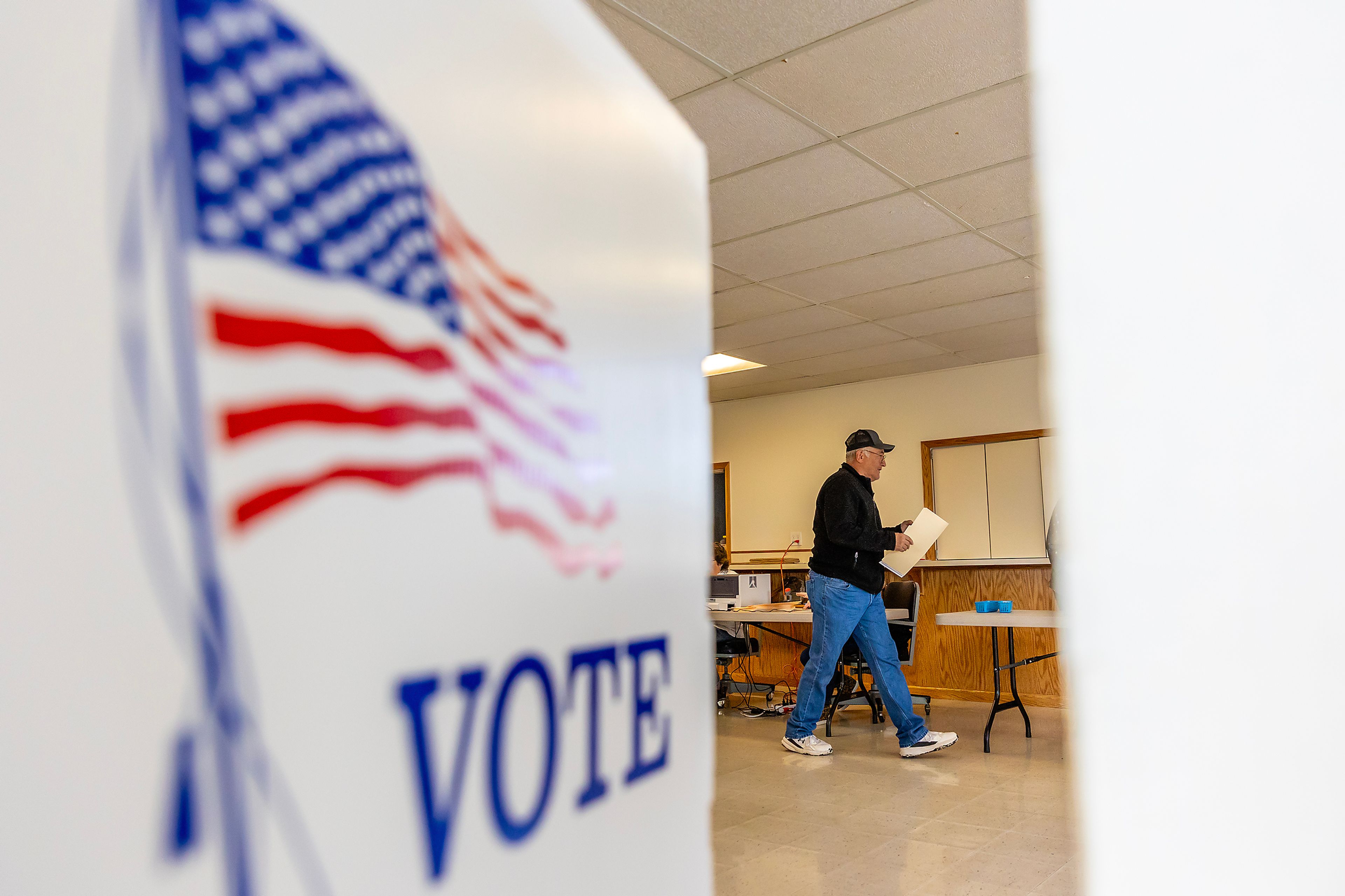 A person walks to a voting booth Tuesday in Craigmont.