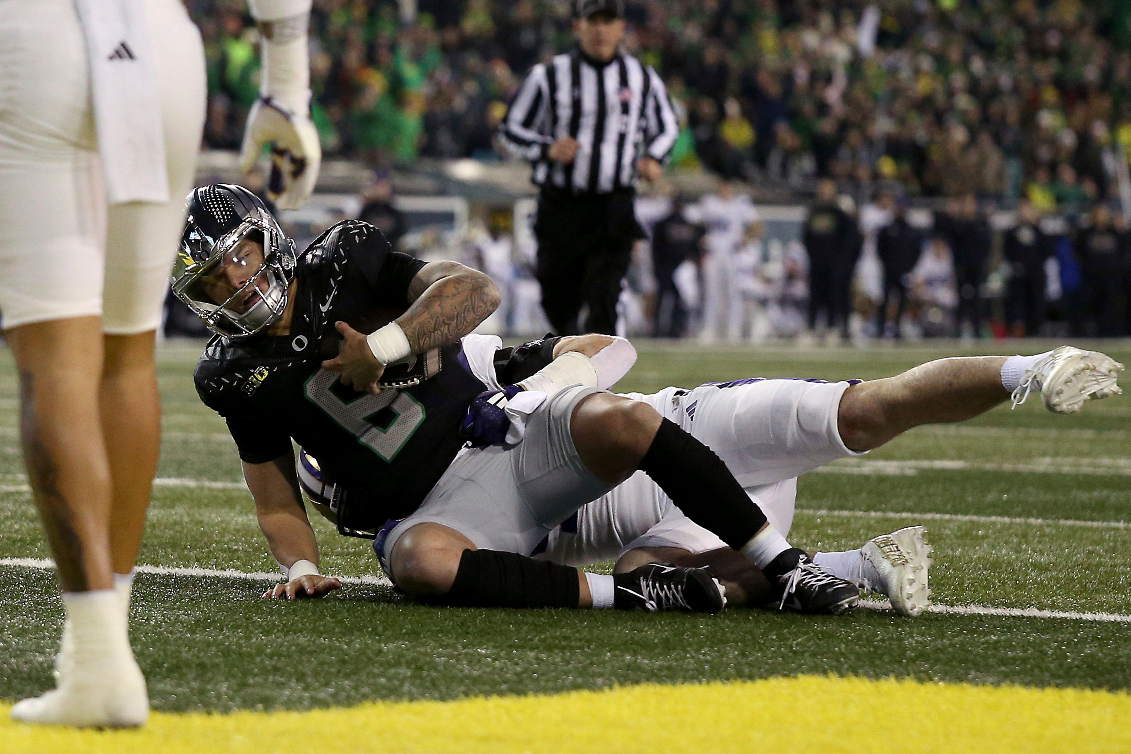 Oregon quarterback Dillon Gabriel (8) falls into the end zone for a touchdown during an NCAA college football game against Washington, Saturday, Nov. 30, 2024, in Eugene, Ore. (AP Photo/Lydia Ely)