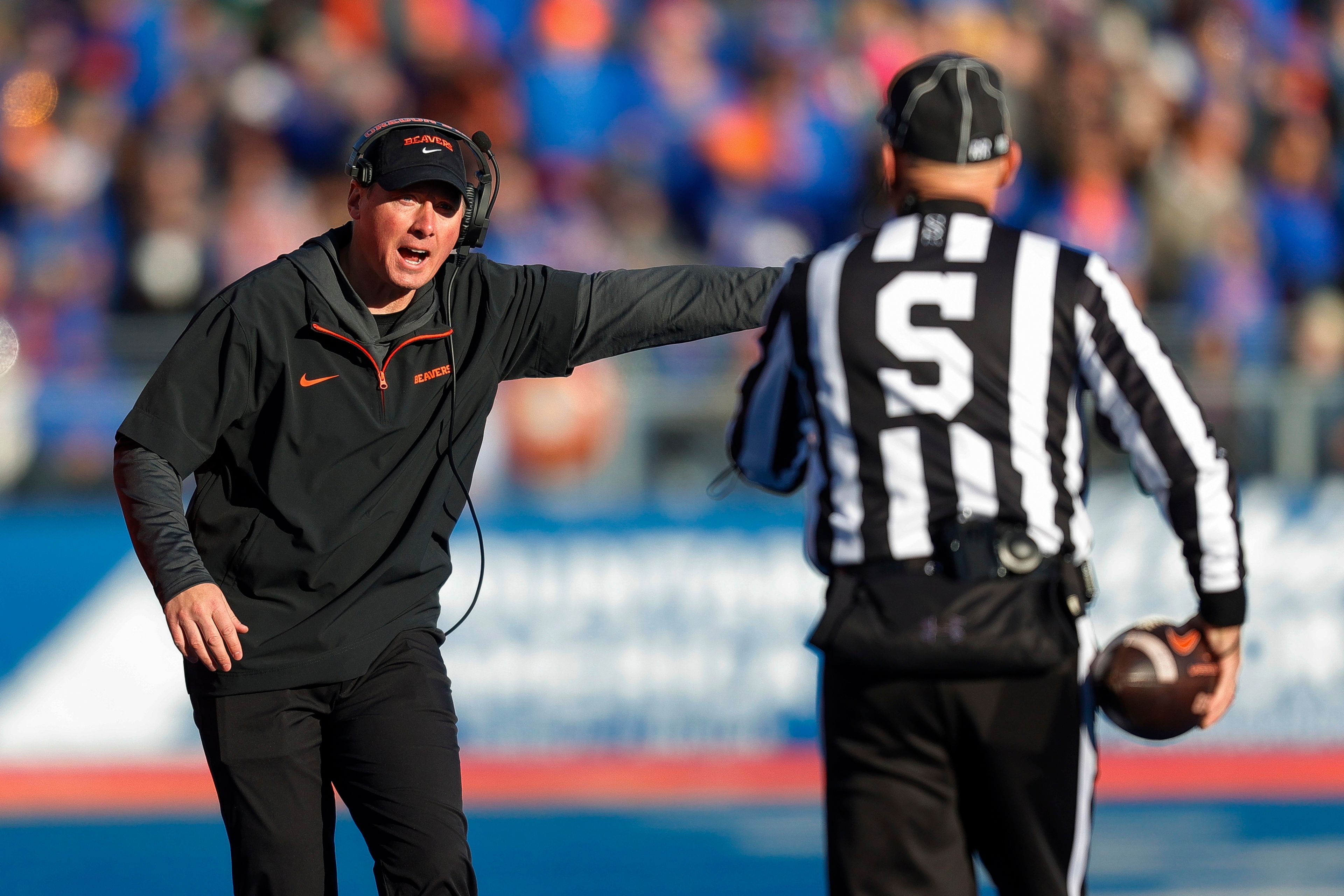 Oregon State head coach Trent Bray talks with side judge about the spot of the ball against Boise State in the first half of an NCAA college football game, Friday, Nov. 29, 2024, in Boise, Idaho. (AP Photo/Steve Conner)