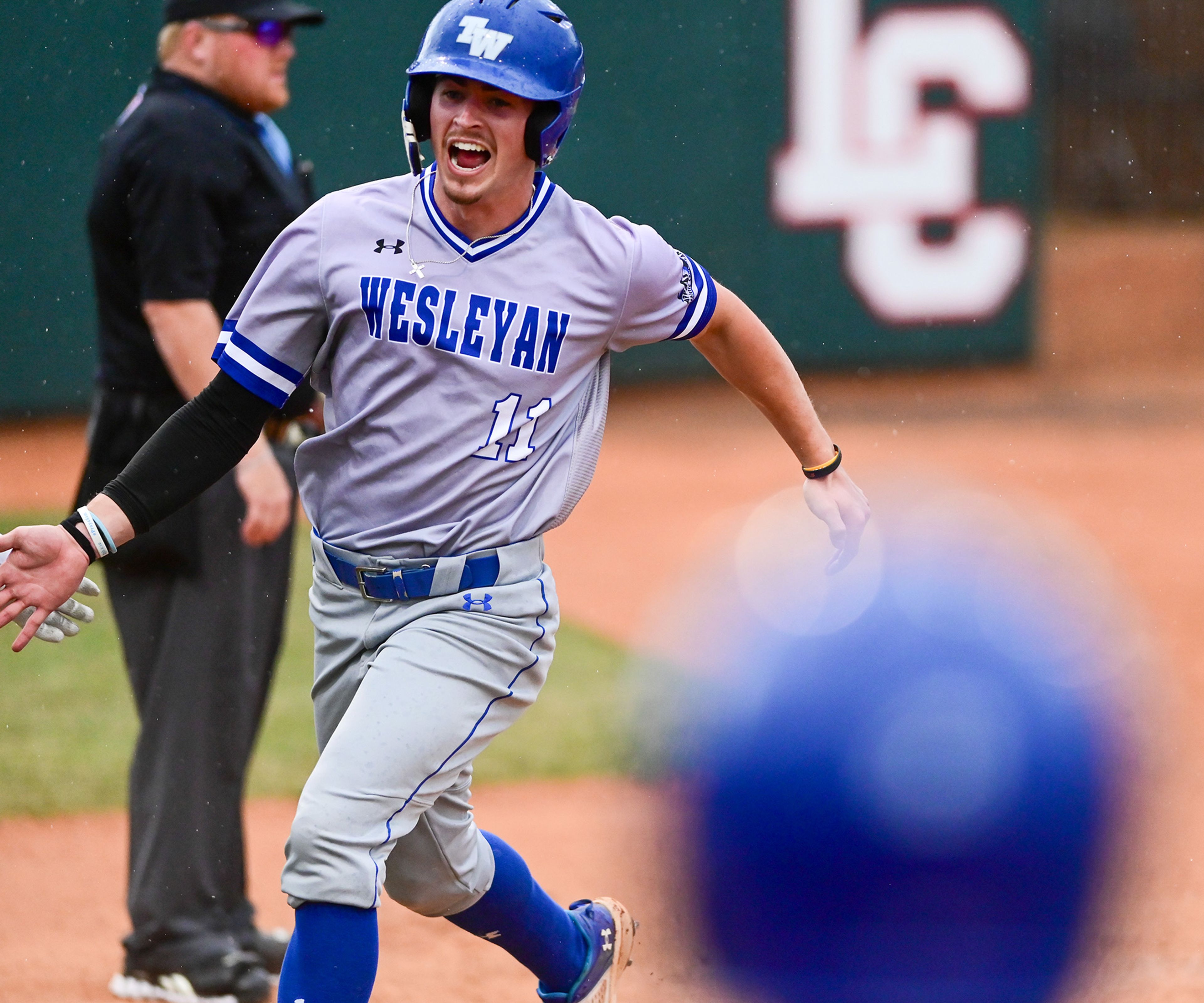 Tennessee Wesleyan’s Carson Ford runs through home plate as rain falls during a game against Cumberlands on the opening day of the NAIA World Series at Harris Field in Lewiston on Friday.