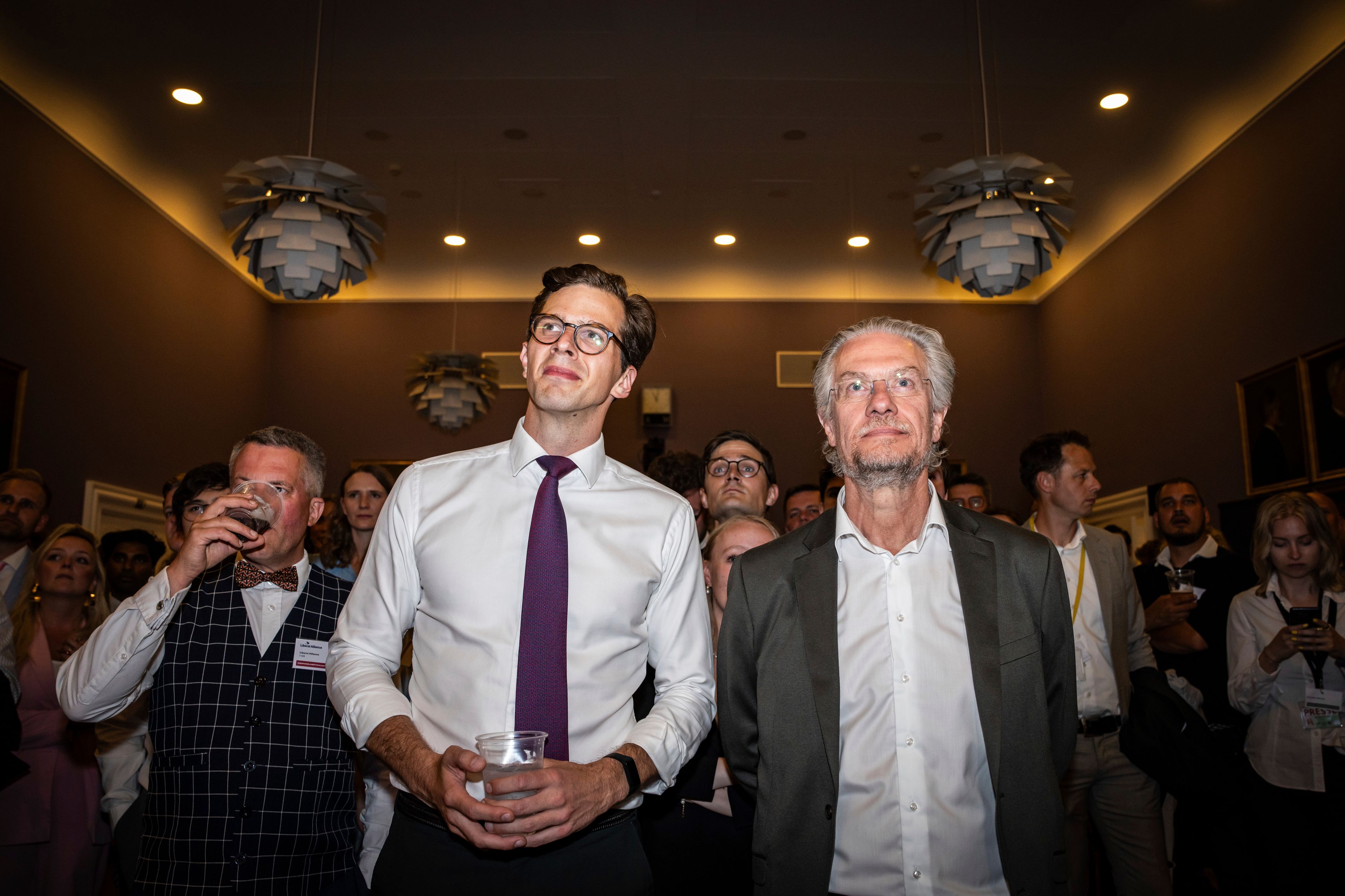 Party leader of the Liberal Alliance Alex Vanopslagh, left, and party member Henrik Dahl stand during an election party at Christiansborg in Copenhagen, Sunday, June 9, 2024.