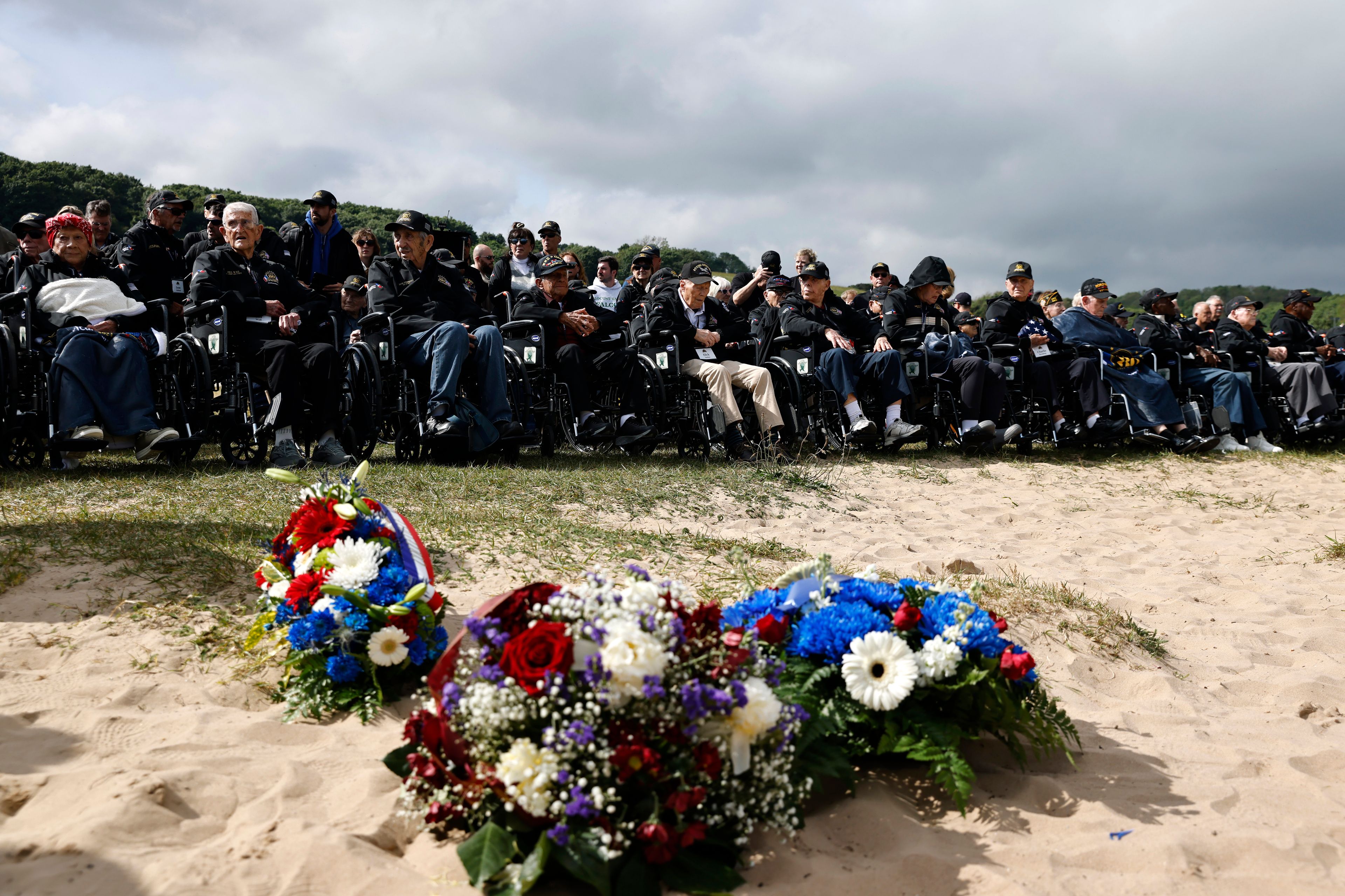 American D-Day veterans gather for a ceremony on Omaha Beach, Tuesday, June 4, 2024 in Normandy. World War II veterans from across the United States as well as Britain and Canada are in Normandy this week to mark 80 years since the D-Day landings that helped lead to Hitler's defeat. (AP Photo/Jeremias Gonzalez)