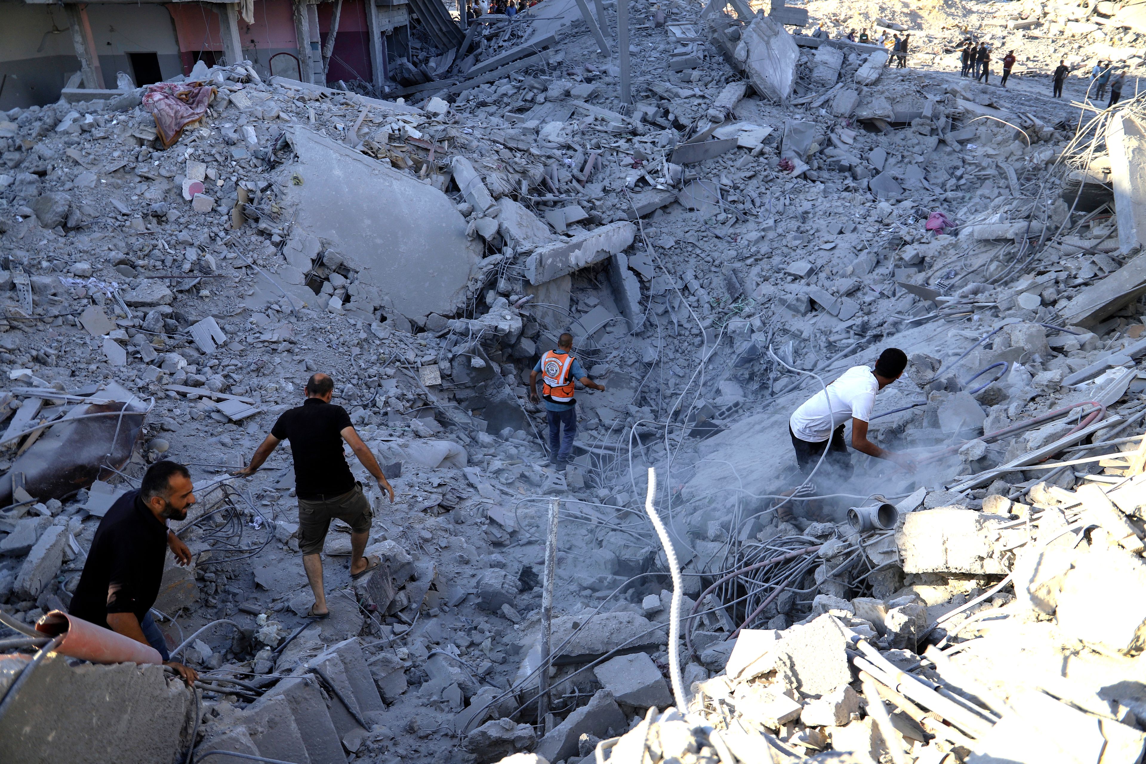 Palestinians search for bodies and survivors in the rubble of a residential building destroyed in an Israeli airstrike in Khan Younis, Gaza Strip, Wednesday, July 3, 2024. (AP Photo /Jehad Alshrafi)