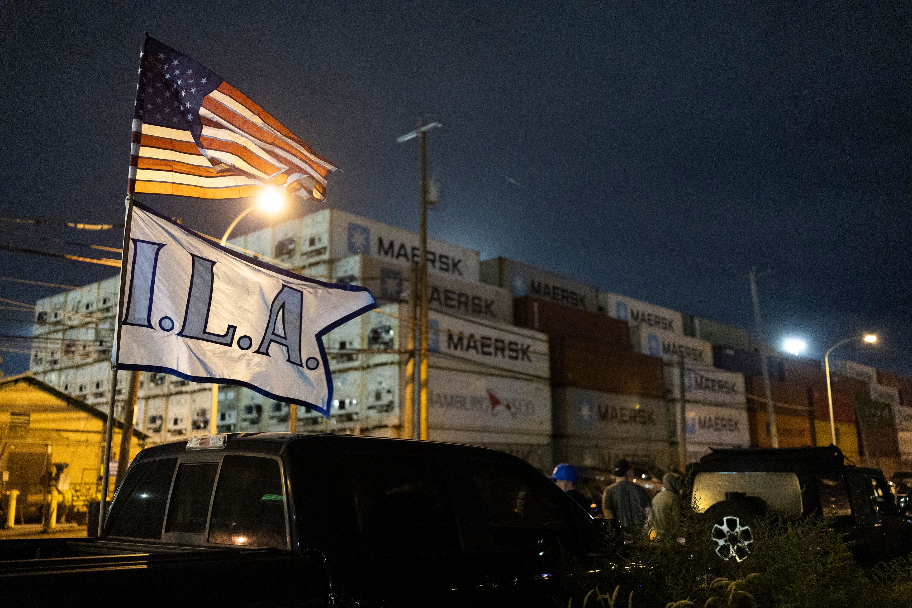 The International Longshoremenâ€™s Association flag and an American flag fly together outside the Packer Avenue Marine Terminal Port as workers prepare to strike as their contract runs out at midnight, Monday, Sept. 30, 2024. (AP Photo/Ryan Collerd)