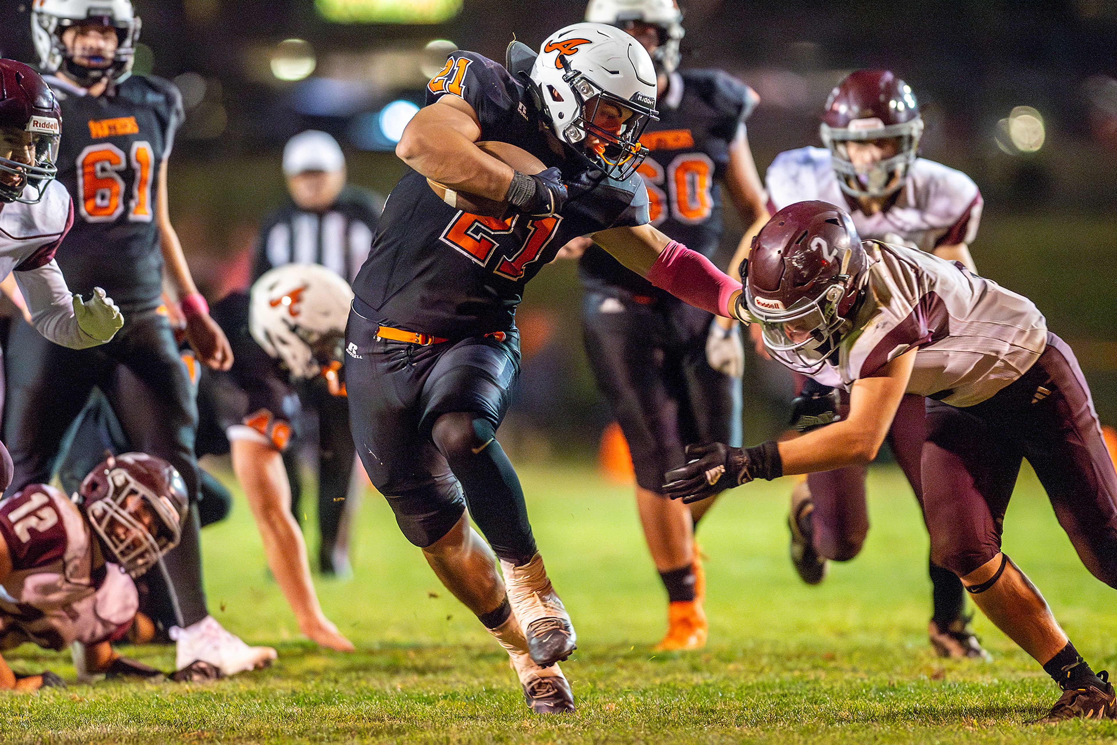 Asotin running back Colt Kelley stiff arms Reardan�s Hunter Flaa during a Northeast 2B League game Friday in Asotin.,