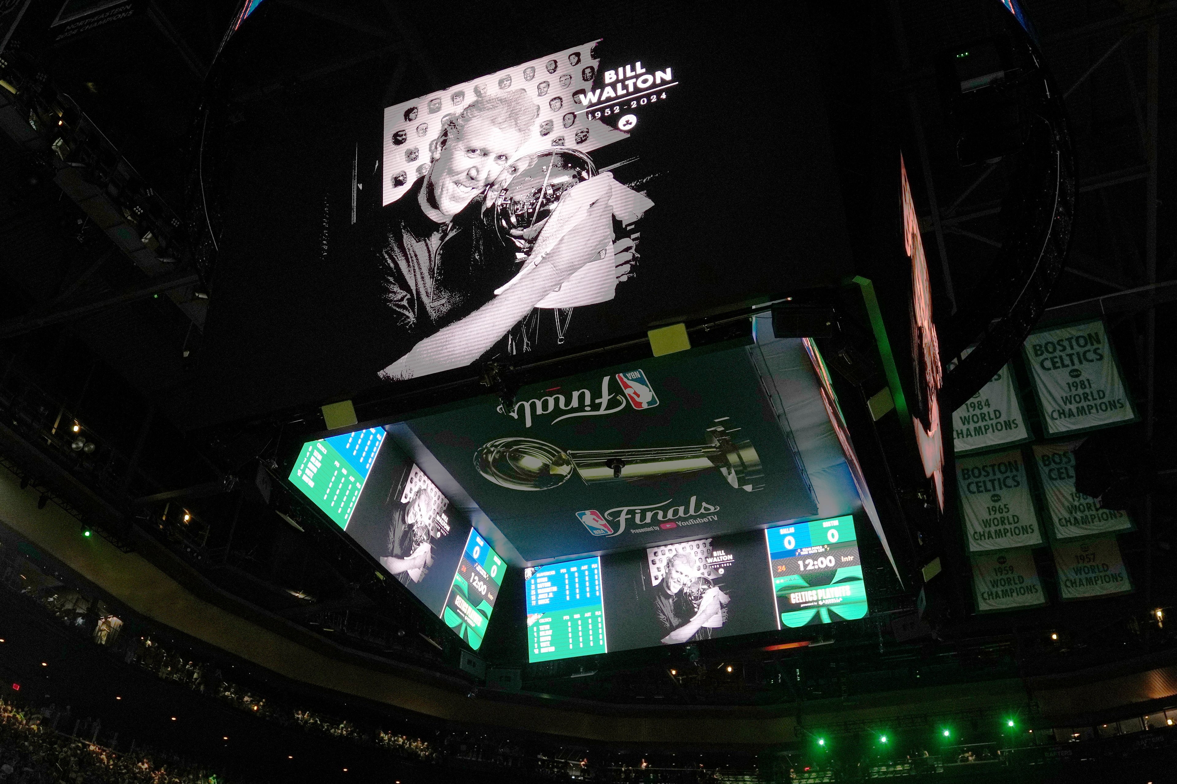 A display honoring basketball great Bill Walton appears on a screen before Game 1 of basketball's NBA Finals between the Boston Celtics and the Dallas Mavericks, Thursday, June 6, 2024, in Boston.