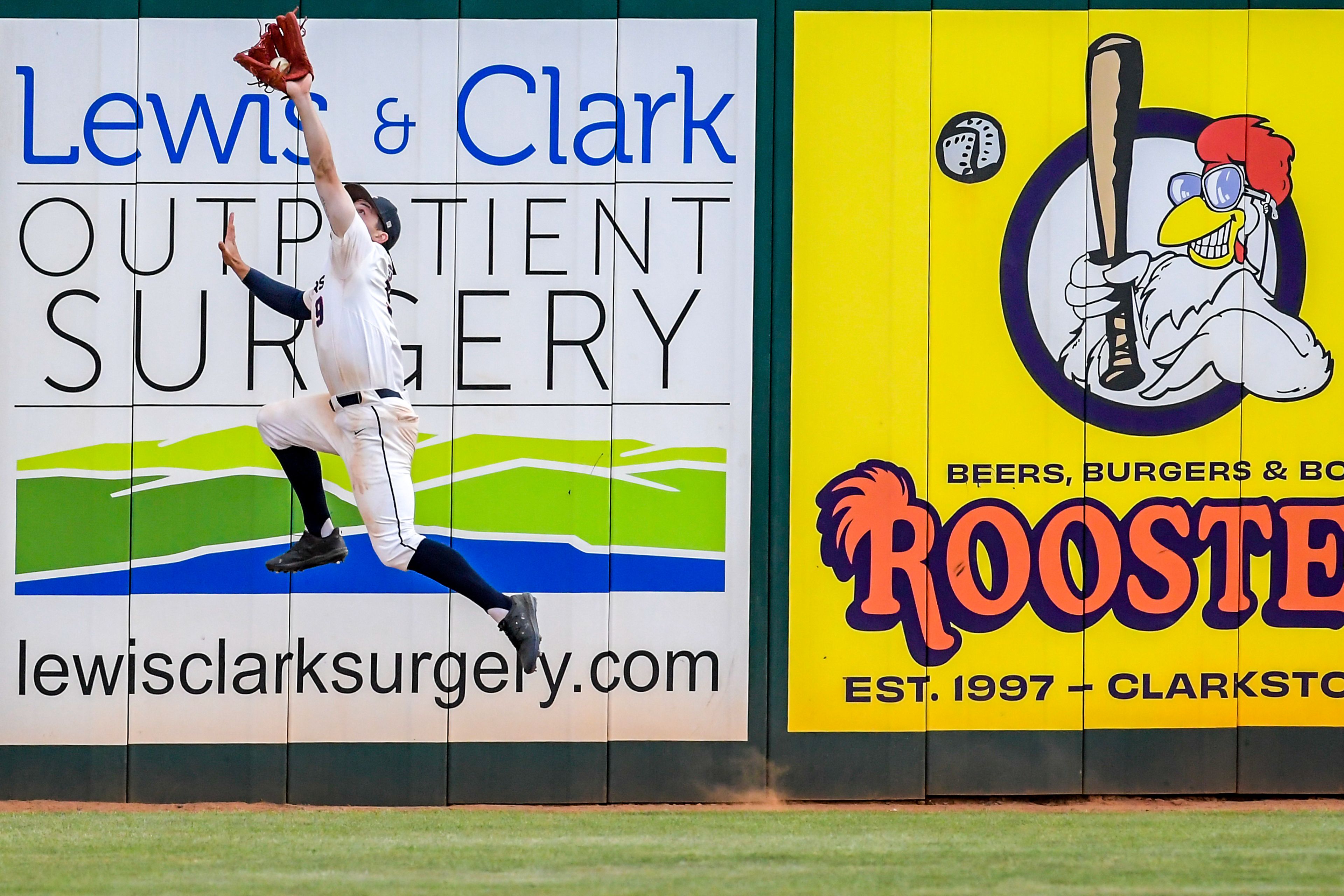 Lewis-Clark State middle fielder Carter Booth makes a catch against UBC in an inning of a first round game of the NAIA Opening Round Monday at Harris Field in Lewiston.