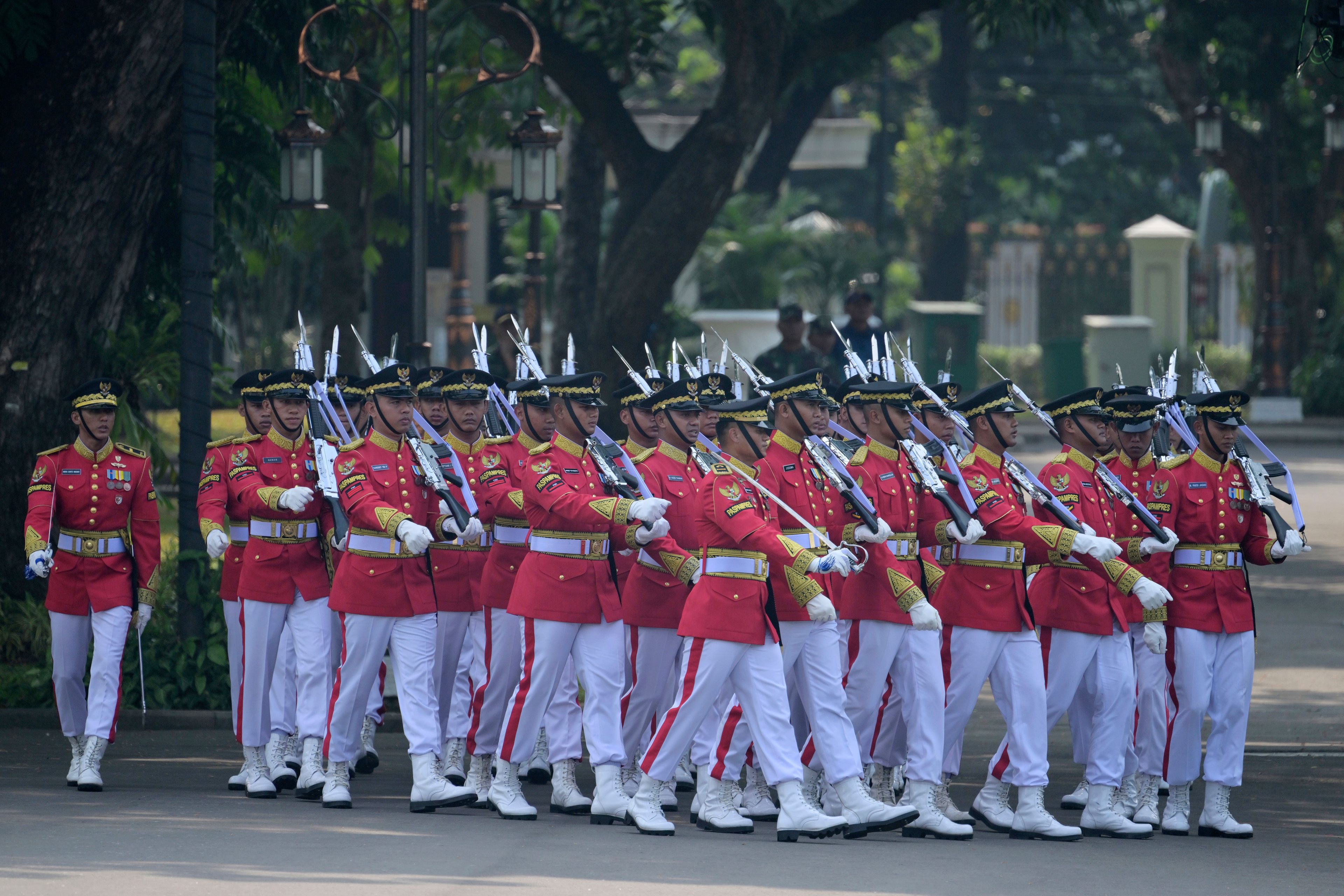 Members of an honour guard march to positions ahead of the ceremonial welcome for Pope Francis at the Presidential Palace in Jakarta Wednesday, Sept. 4, 2024.