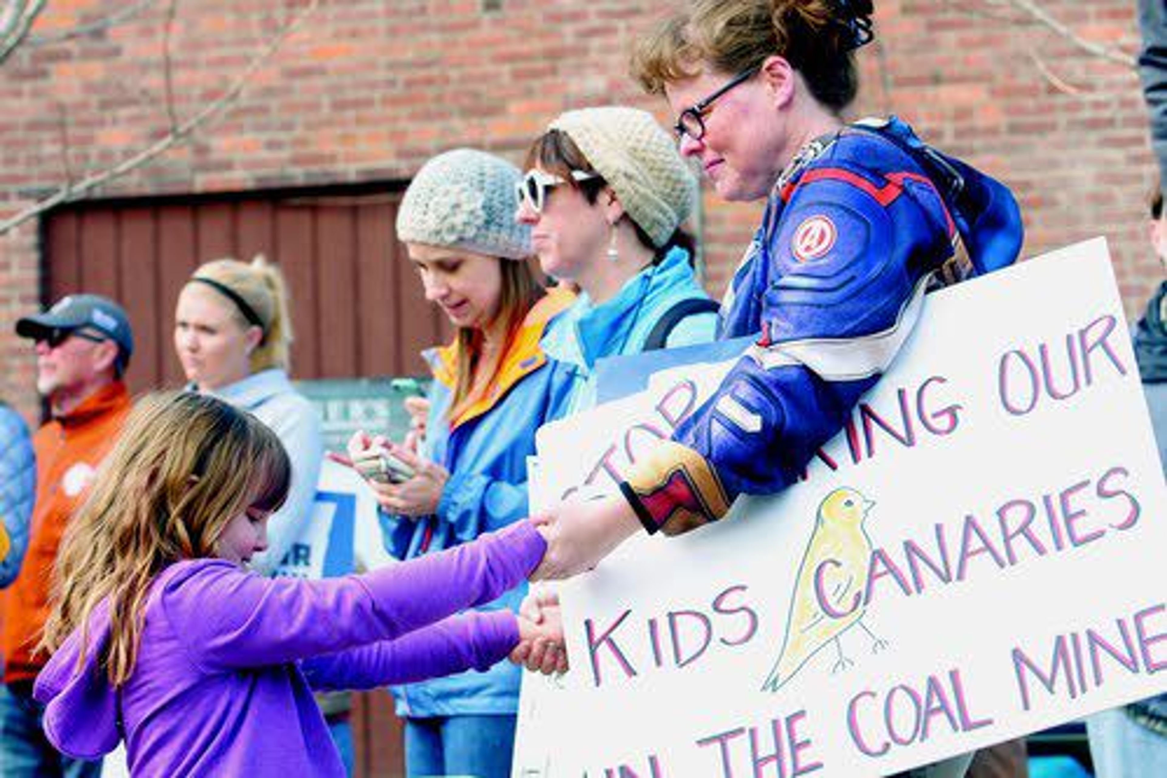 LEFT: Johanna Bjork of Lewiston (right) plays with her daughter, Nora, 6, while holding a sign under her arm at the March for Our Lives Rally in downtown Lewiston.