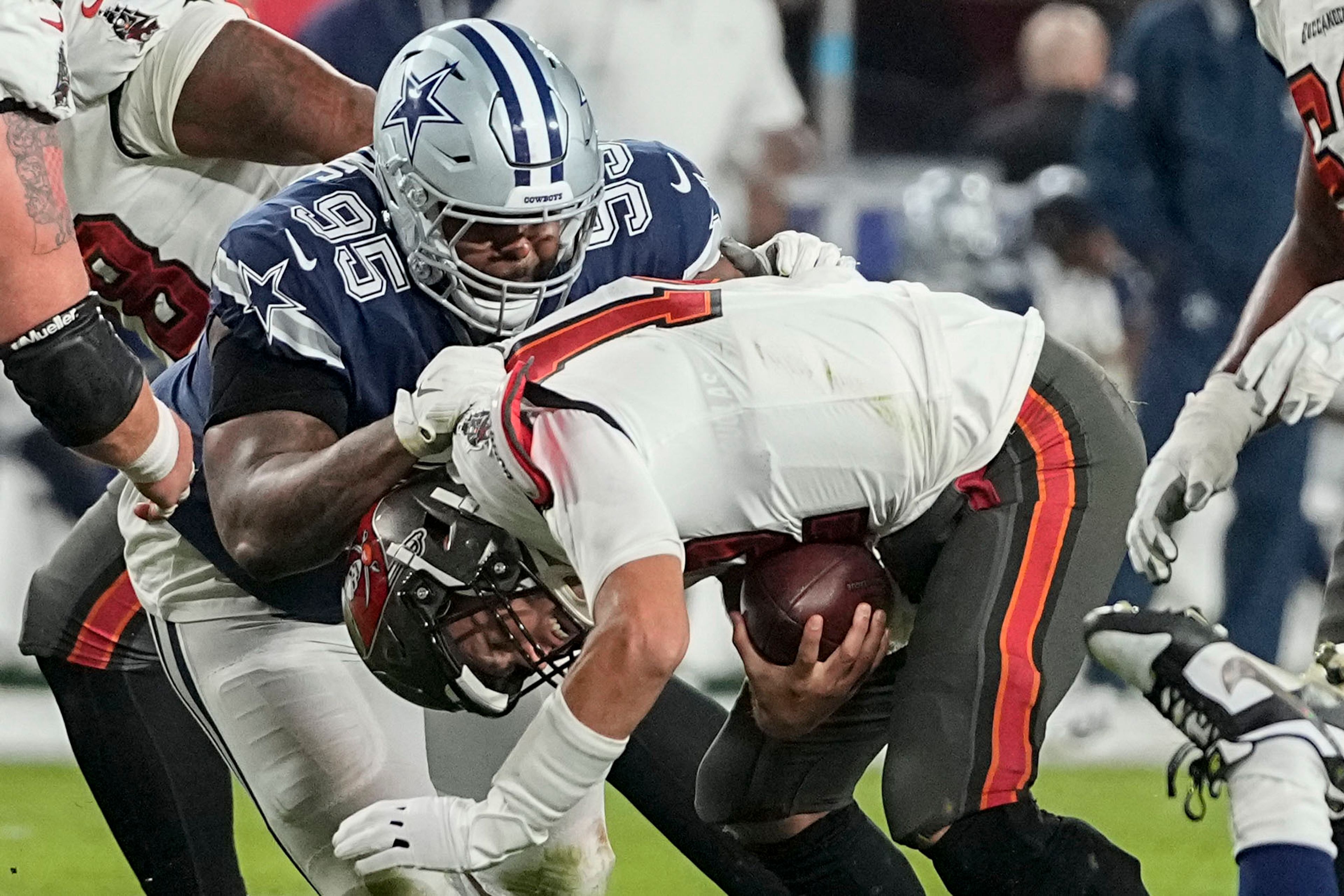 Dallas Cowboys defensive tackle Johnathan Hankins (95) sacks Tampa Bay Buccaneers quarterback Tom Brady (12) during the second half of an NFL wild-card football game, Monday, Jan. 16, 2023, in Tampa, Fla. (AP Photo/Chris Carlson)