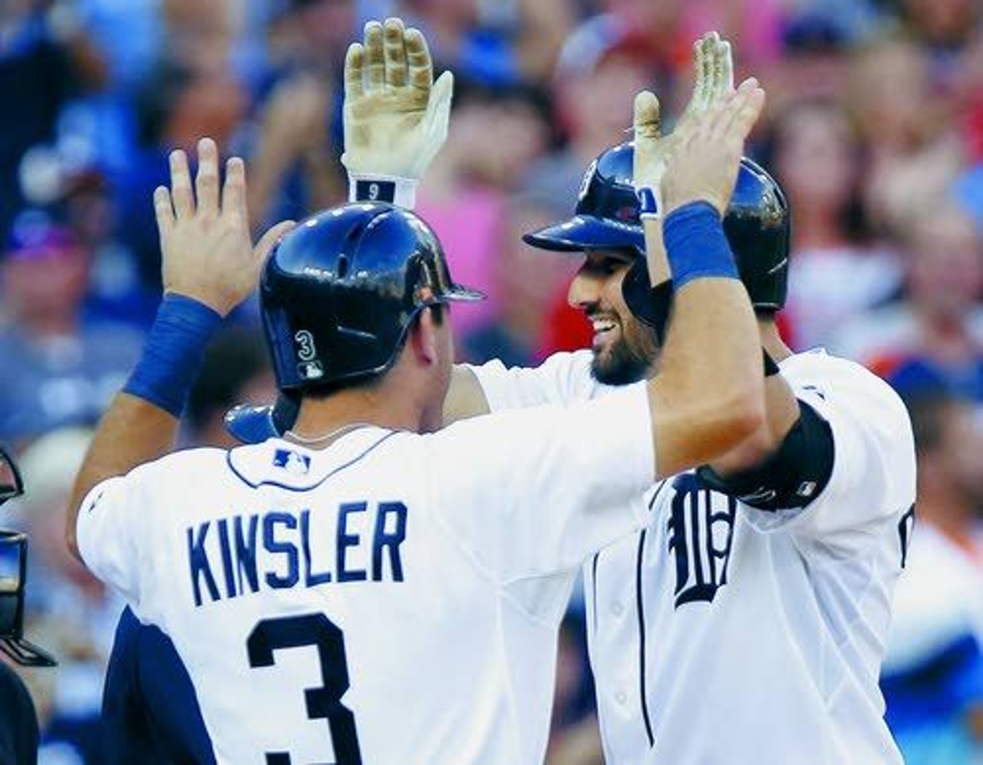 Detroit’s Nick Castellanos (right), celebrates his grand slam with teammate Ian Kinsler (3) during the third inning against the Mariners. The Tigers exploded for eight runs in the third inning — four of which came on this blast — then held on late to beat the Mariners 9-4 Wednesday.