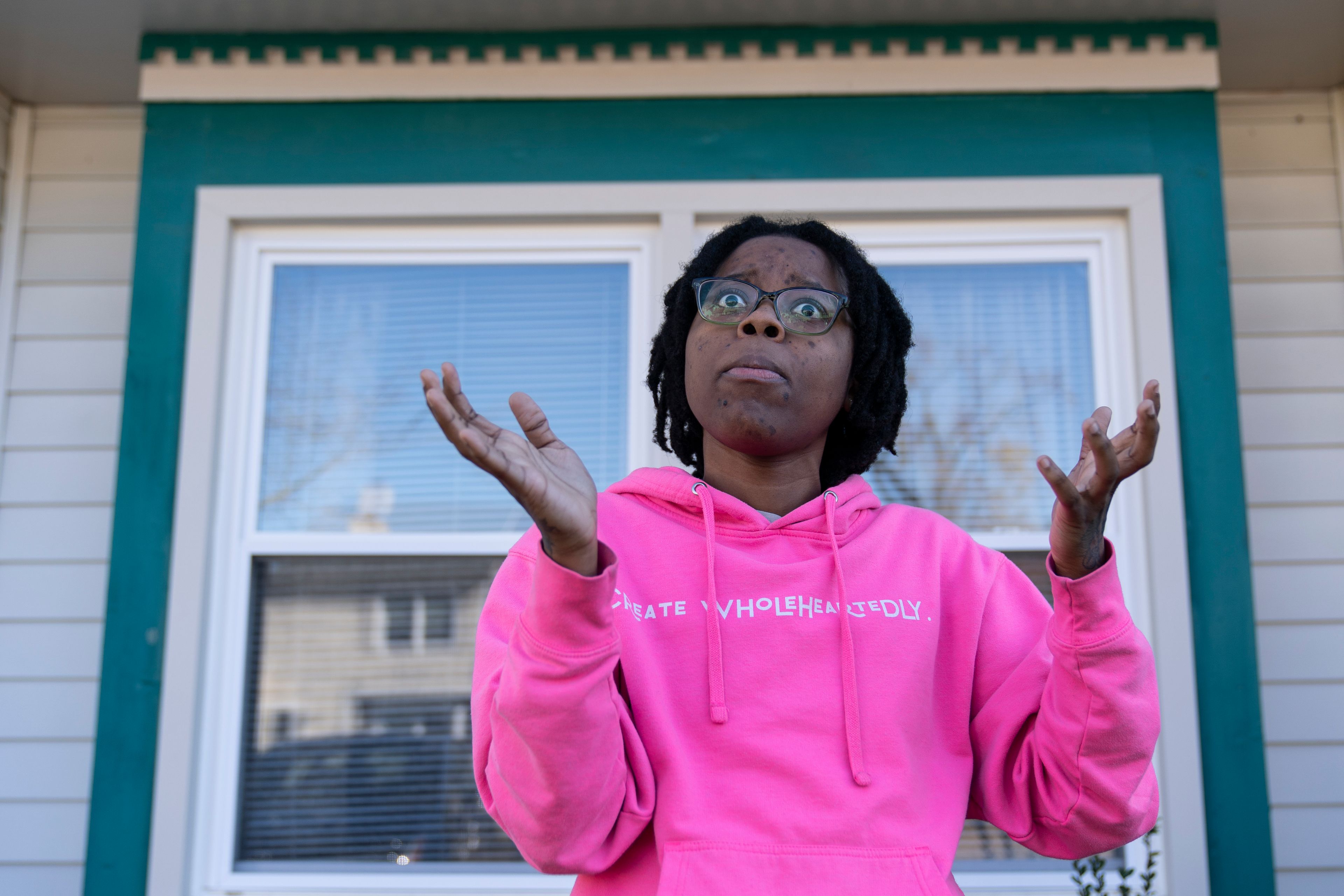 Briana Tyler speaks with The Associated Press about witnessing the mass shooting at a Walmart, Wednesday, Nov. 23, 2022, in Chesapeake, Va. Tyler said the overnight stocking team of about 15 or 20 people had just gotten together in the break room to go over the morning plan. As soon as the team was set to start, she said she looked up, and her manager turned around and opened fire on the staff. (AP Photo/Alex Brandon)