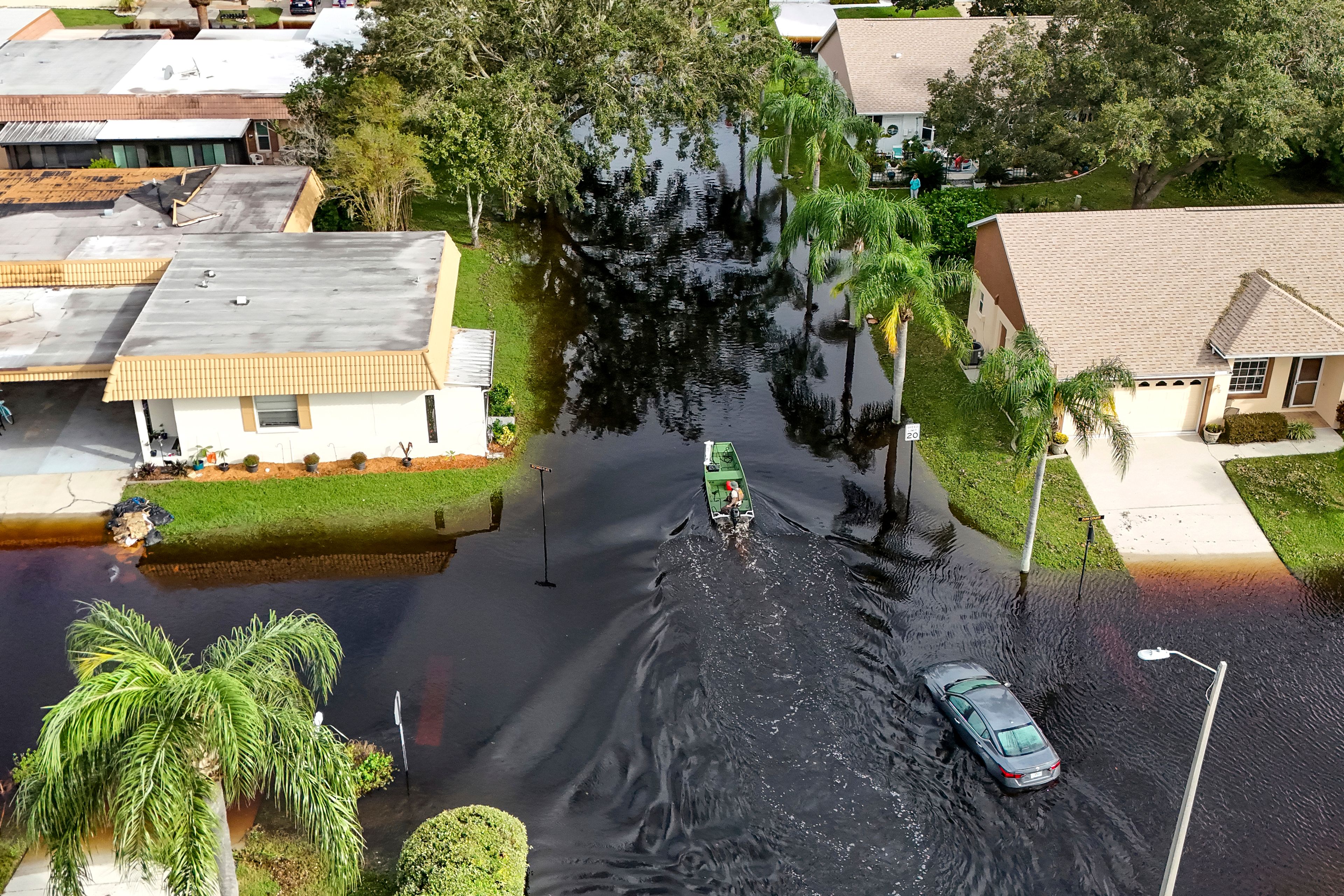 A member of the Pasco County Sheriff's Office goes out to help residents trapped in their homes as waters rise after Hurricane Milton caused the Anclote River to flood, Friday, Oct. 11, 2024, in New Port Richey, Fla. (AP Photo/Mike Carlson)