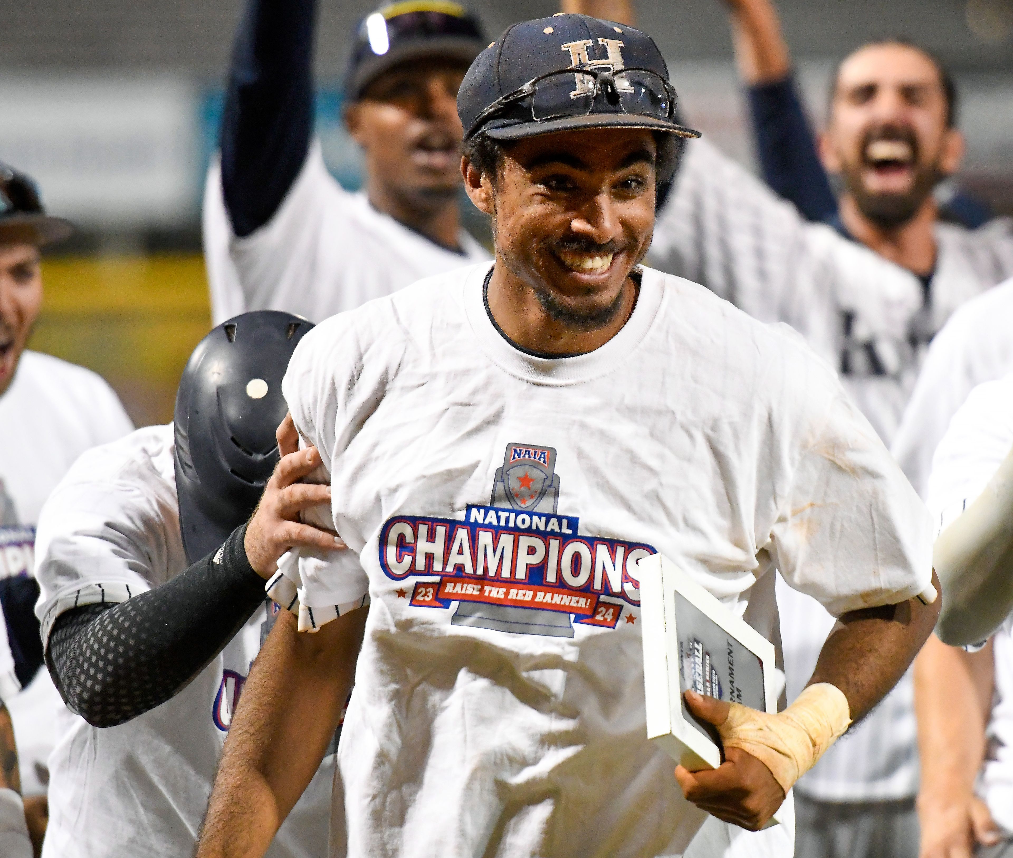 Hope International’s JJ Cruz reacts to being named Most Valuable Player for the NAIA World Series All-Tournament Team at Harris Field in Lewiston on Friday.