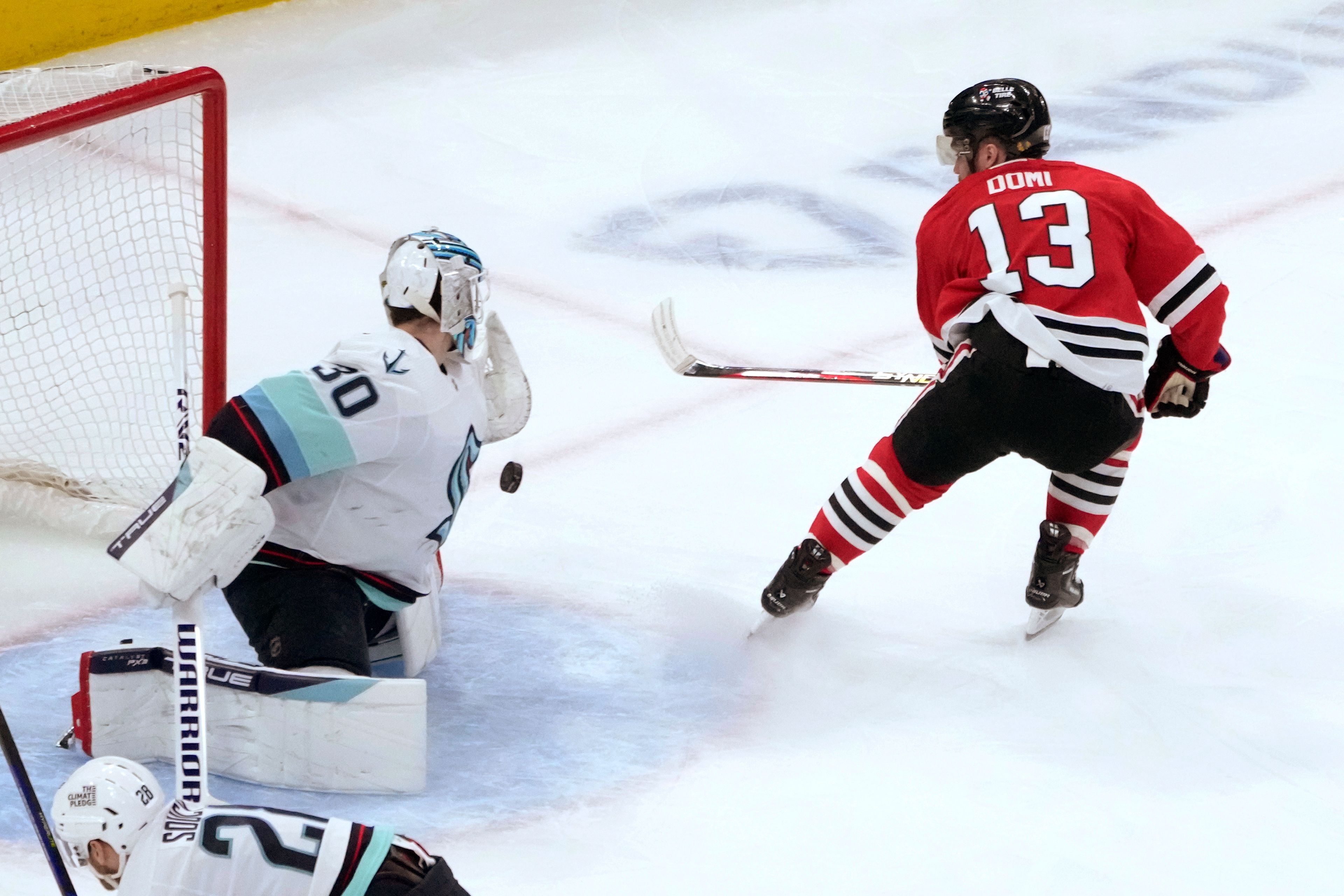 Seattle Kraken goaltender Martin Jones makes a save on a shot by Chicago Blackhawks' Max Domi during the first period of an NHL hockey game Saturday, Jan. 14, 2023, in Chicago. (AP Photo/Charles Rex Arbogast)