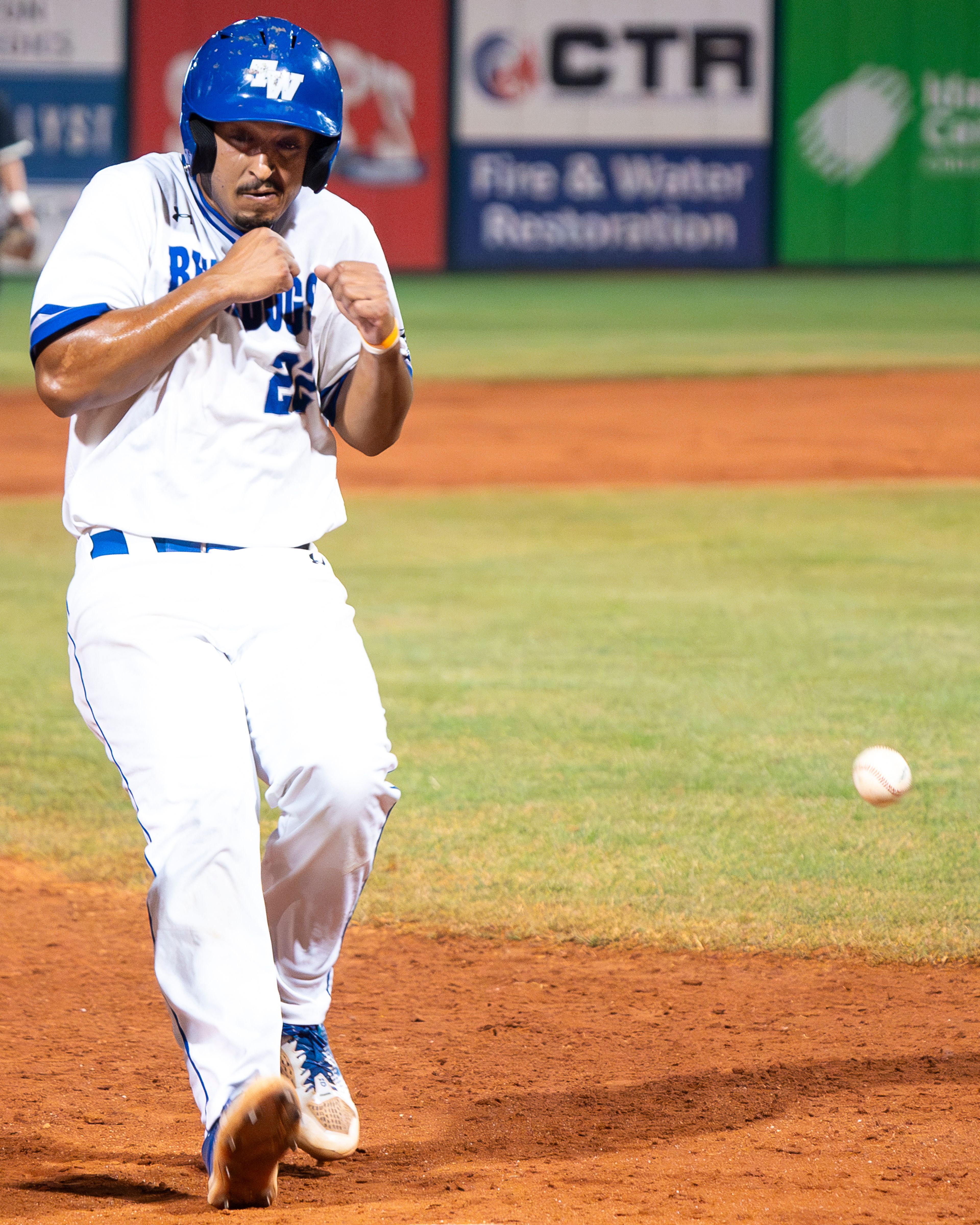 Tennessee Wesleyan’s Marco Martinez braces as he is nearly hit by a ball as he runs to third base during Game 12 of the NAIA World Series against Georgia Gwinnett on Monday at Harris Field in Lewiston.