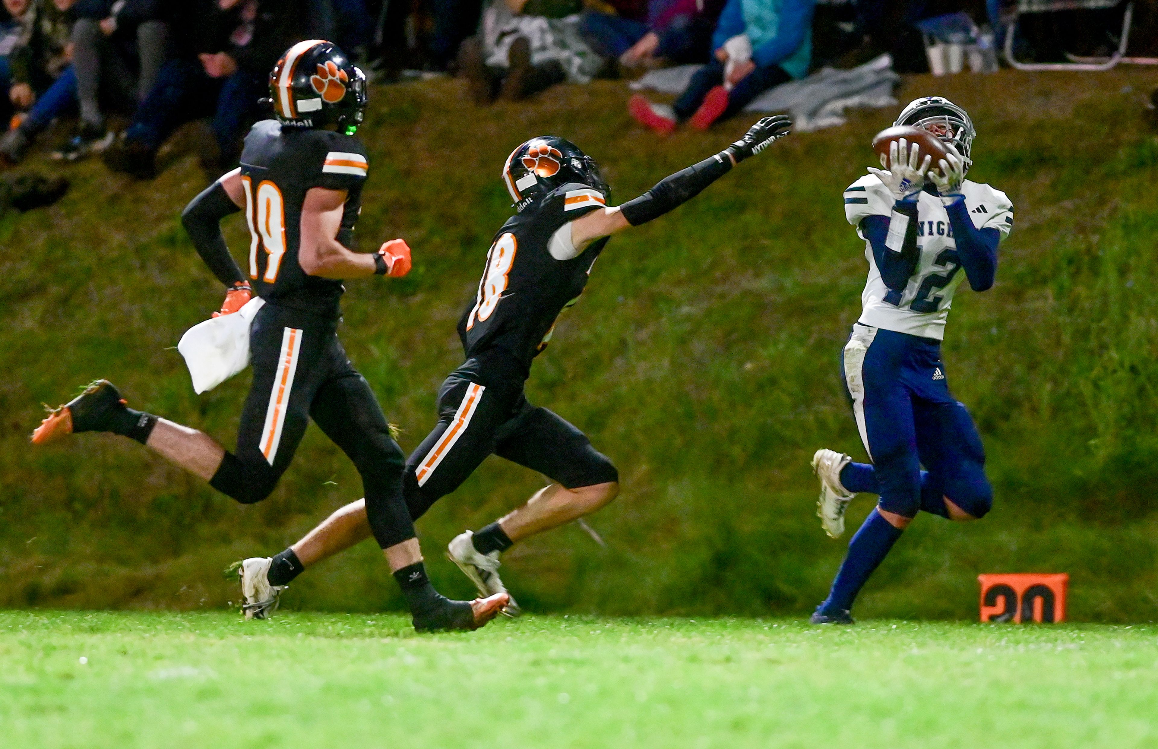 Logos Ryan Daniels completes a pass with pressure from Kendrick defenders Friday in Kendrick.,